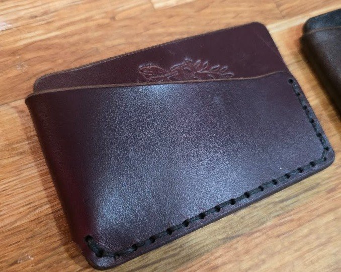 A leather wallet with a stitched border.