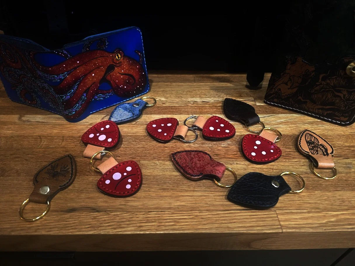 Leather keychains in various shapes and colors.