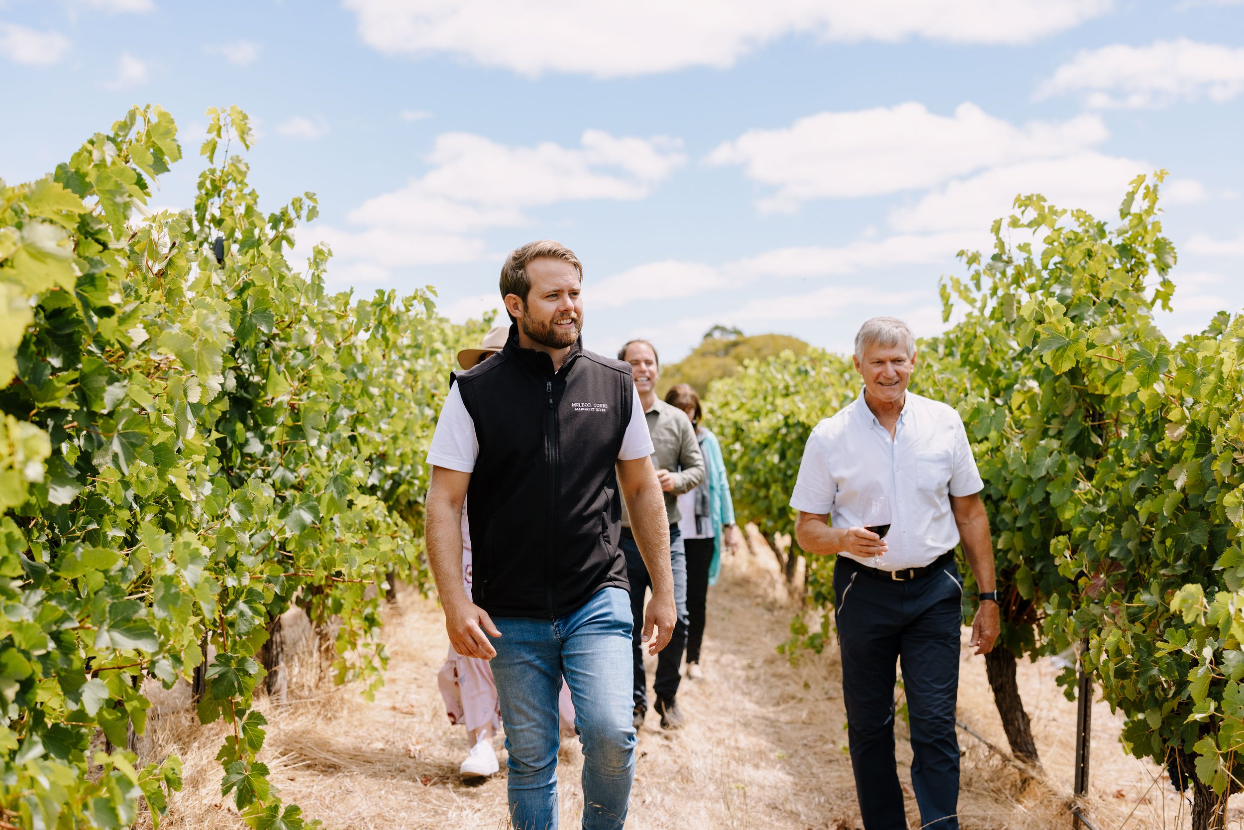 Lincoln McLeod taking guests through a vineyard.