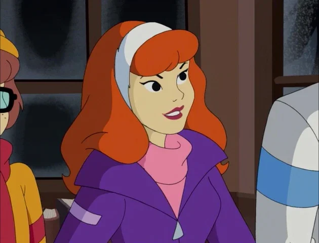 Animated red-haired woman with a white headband, wearing a purple jacket and pink turtleneck, looking to the side in an indoor setting.
