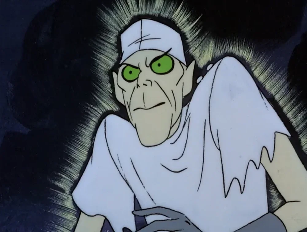 A cartoon character with green eyes, pale skin, black hair, and wearing a white nurse's outfit with a cap, looking sinister with an intense expression.
