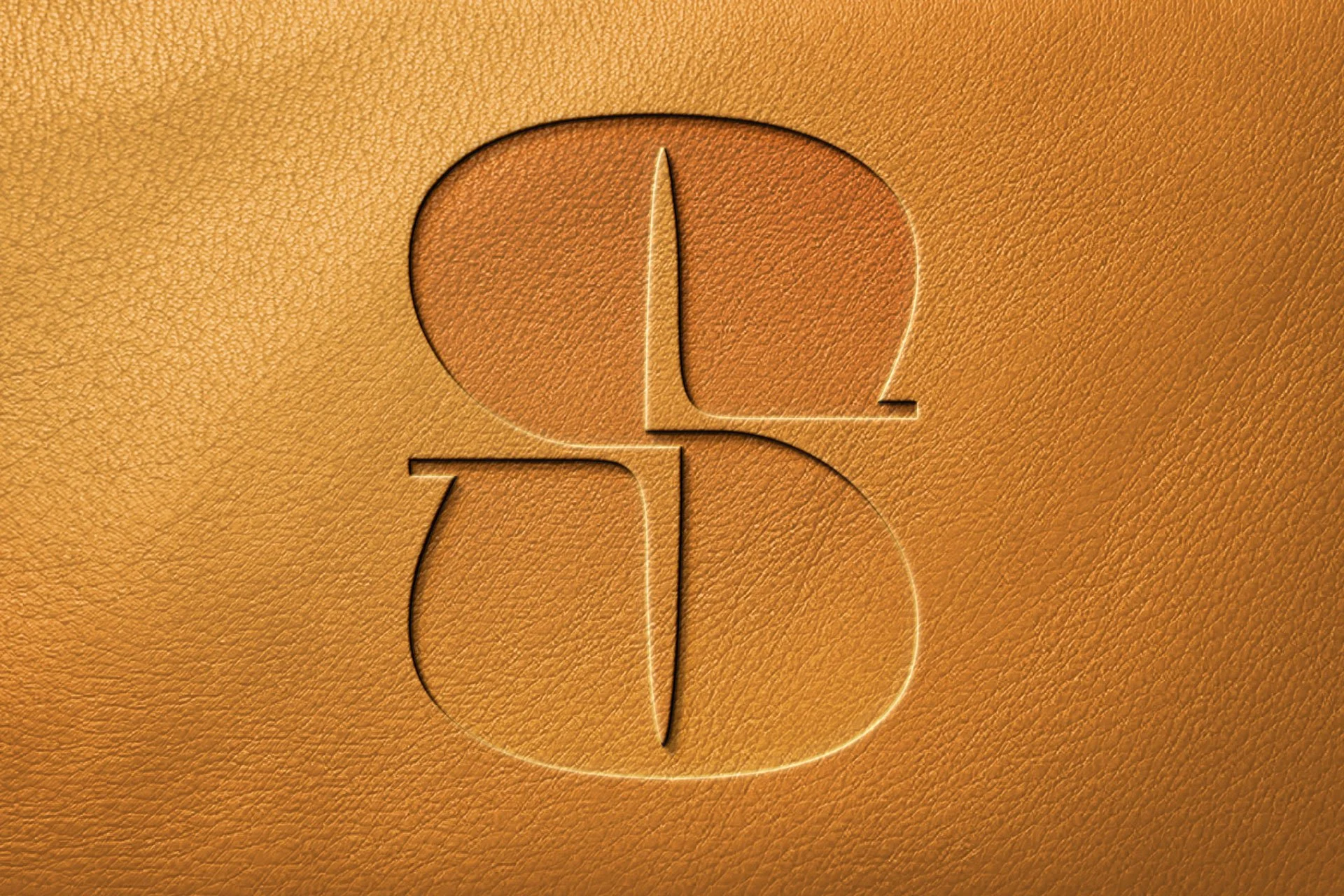 A leather surface with an embossed logo featuring a stylized letter 'B' and 'L' intertwined.