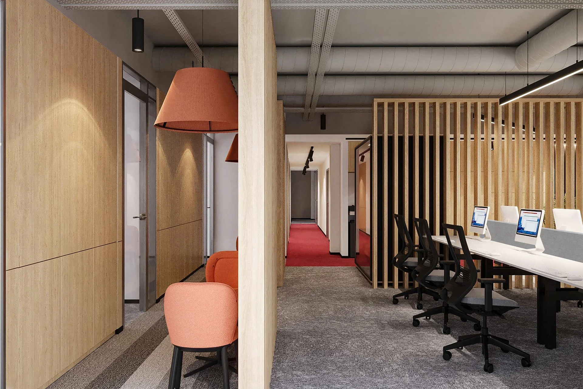 Modern office interior with workstations, computers, black office chairs, wooden partition, orange chairs, pendant lights, and a hallway with red carpet.
