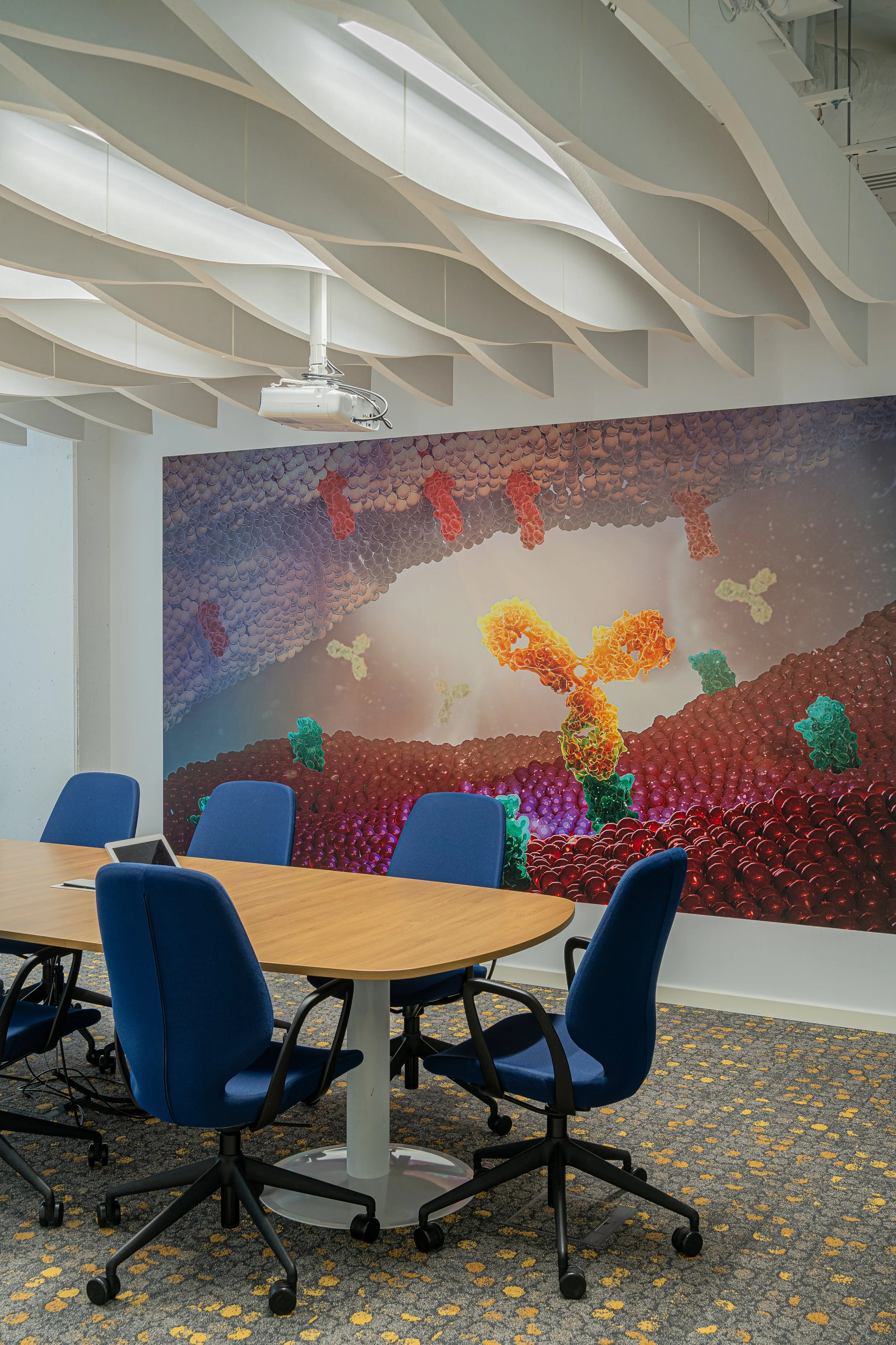 Conference room with a large mural of a microscopic view of DNA strands on the wall.