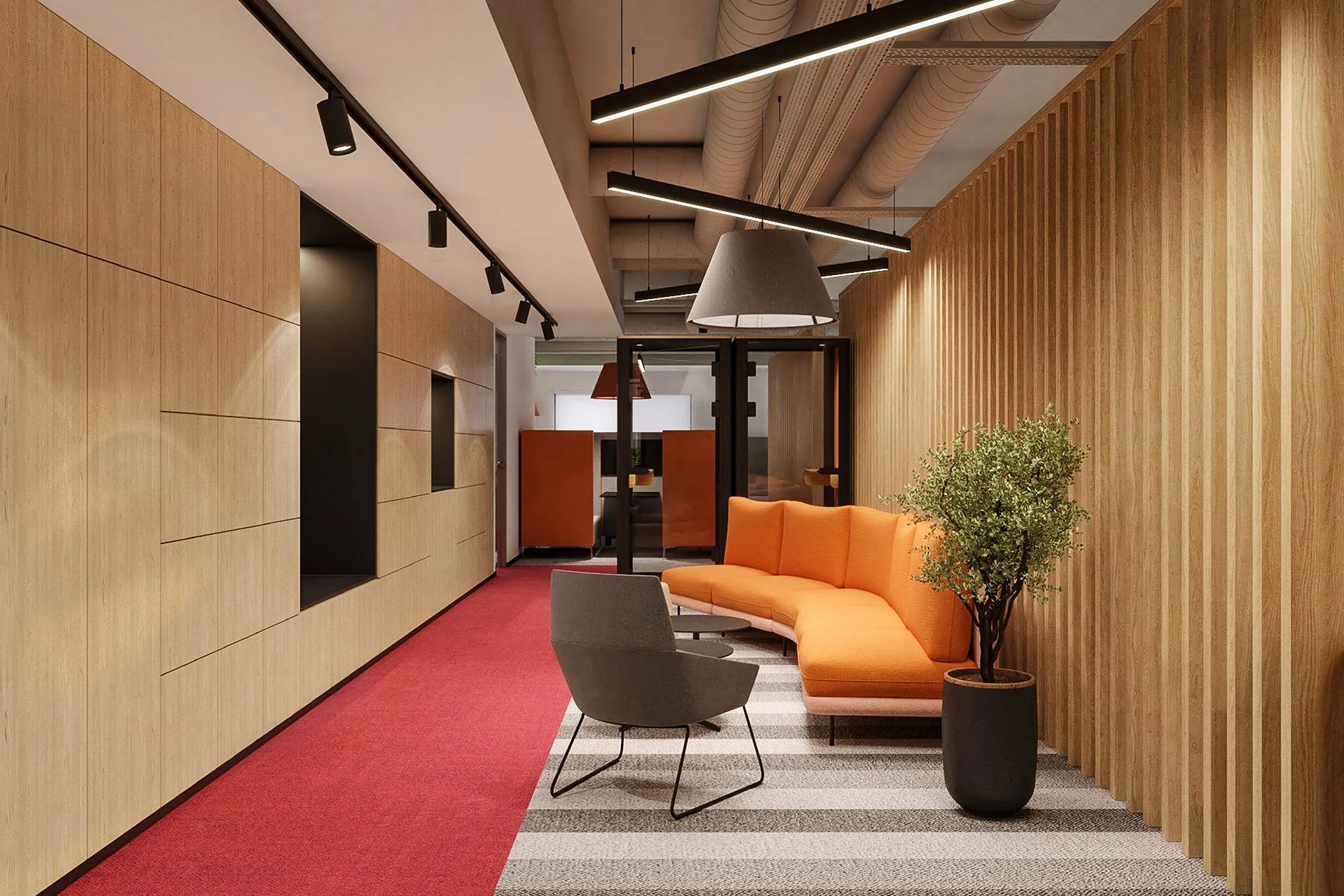 Modern office lounge area with orange sectional sofa, gray armchair, potted plant, wood-paneled walls, and striped carpet, illuminated by track and pendant lighting.