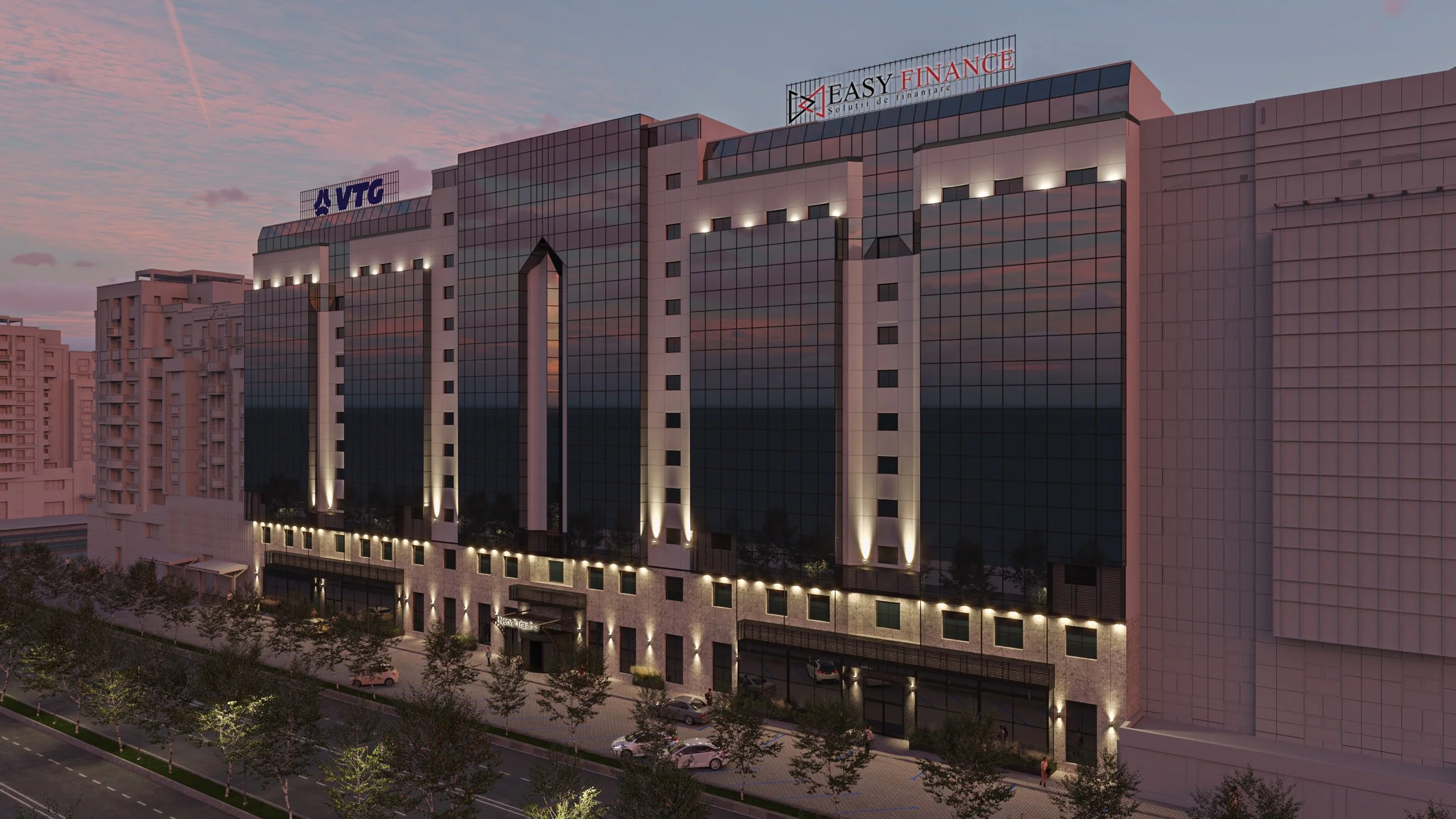 A modern multi-story office building with reflective glass windows at dusk, featuring illuminated exterior lighting and signage for VTG and Easy Finance, with a row of trees and parked cars in front.