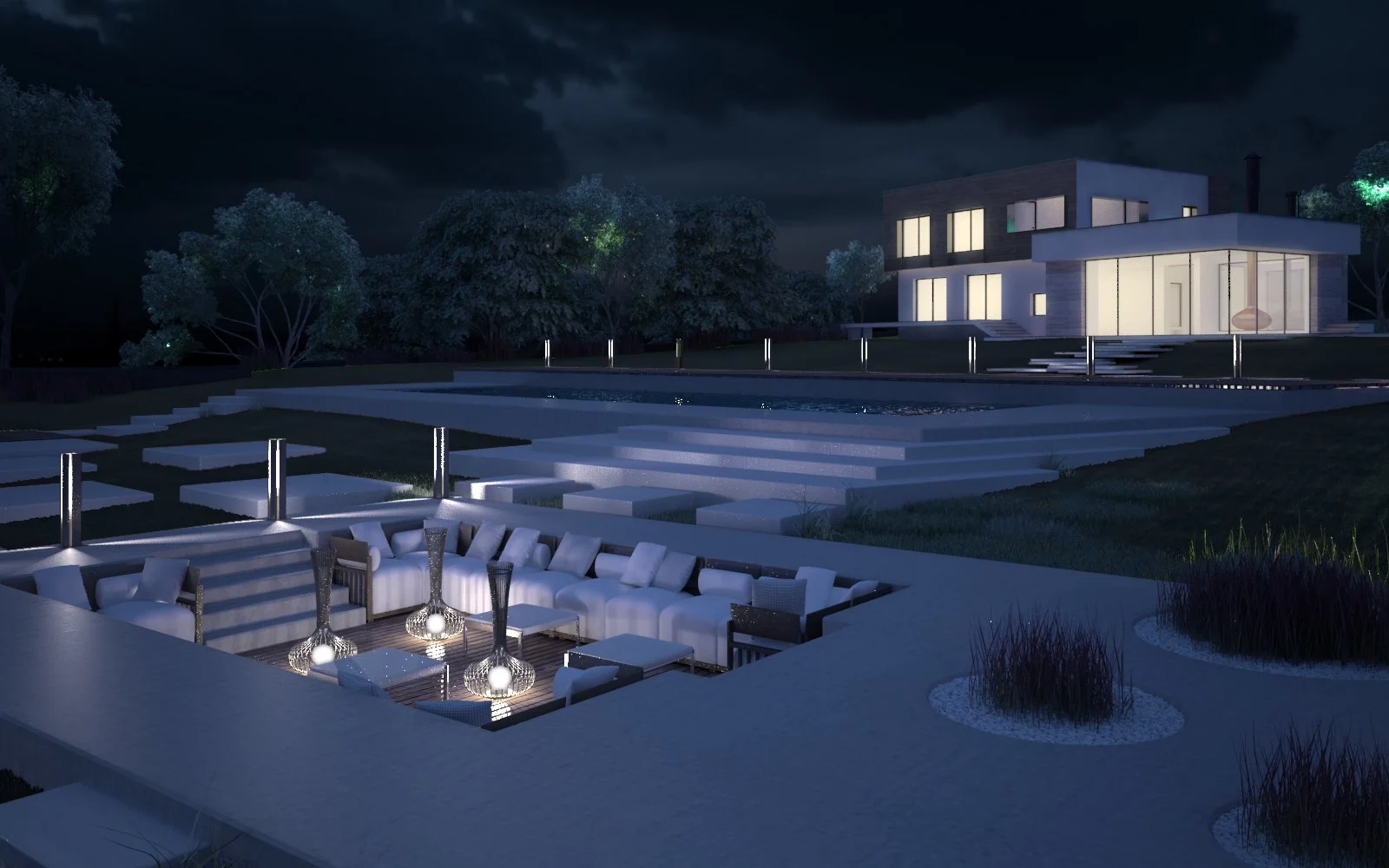 Night view of a modern house with large windows, outdoor seating area with cushions and decorative lighting, surrounded by a landscaped yard with trees and stairs leading to the house and pool area.