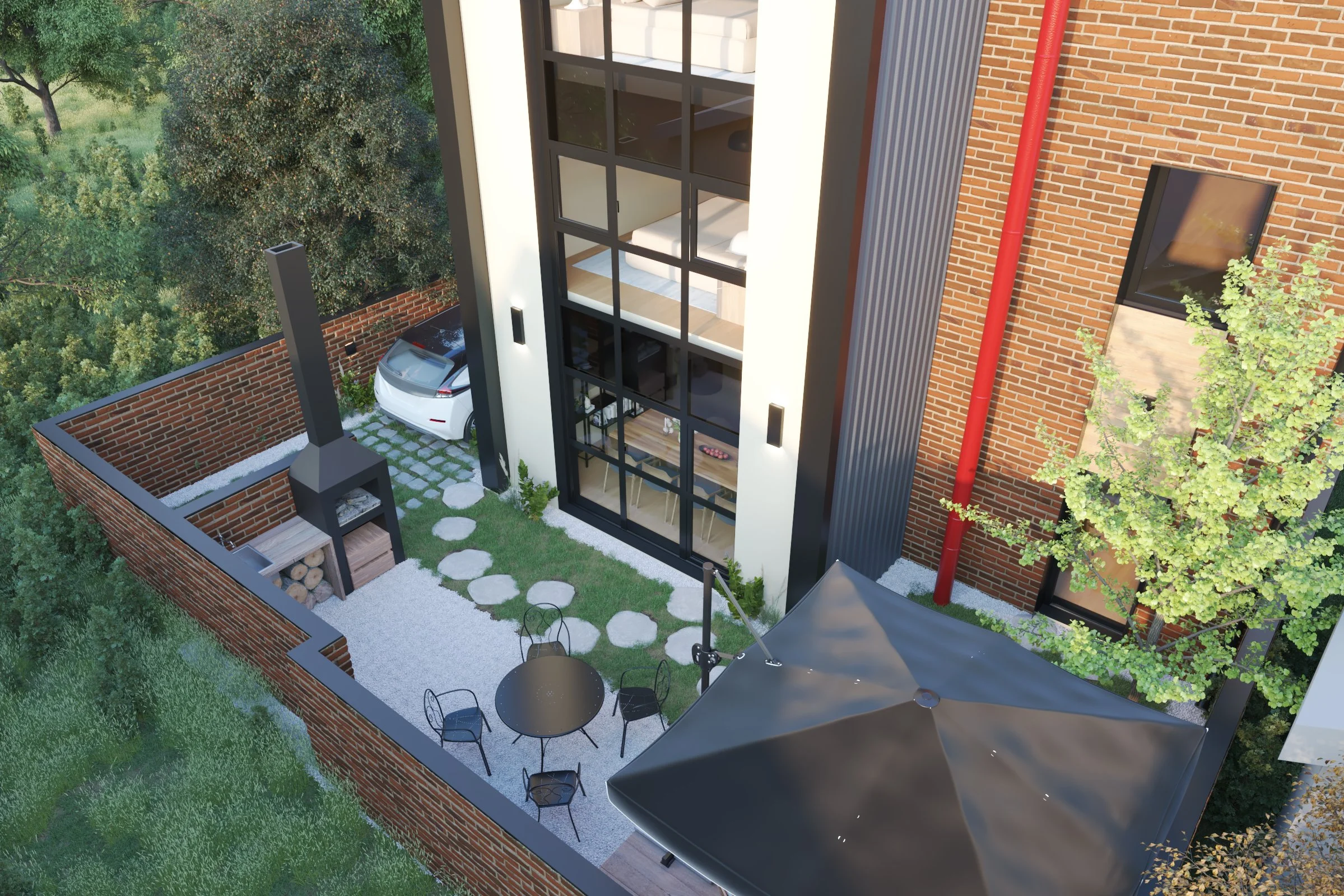 A small outdoor patio backyard with stone pathway, black table and chairs, fire place, enclosed by a brick wall, next to a modern house with large glass windows, and greenery including trees.