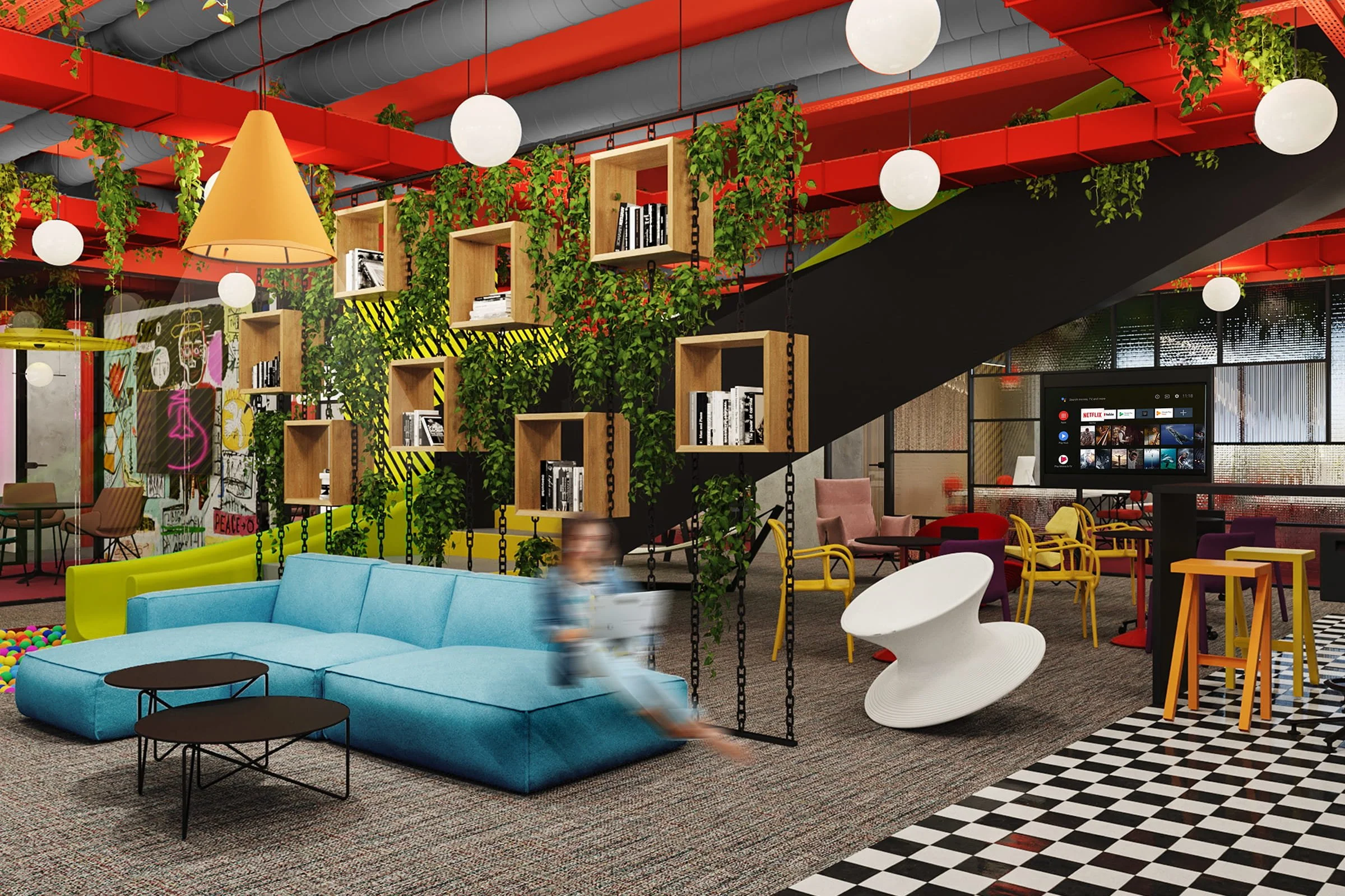 Modern, colorful lounge area with a light blue sectional sofa, round black coffee tables, a white sculptural chair, hanging wooden shelves with books, green plants, and a large television screen in the background. The space features a black and white checkered floor section, vibrant yellow, purple, and red chairs, and pendant lighting.