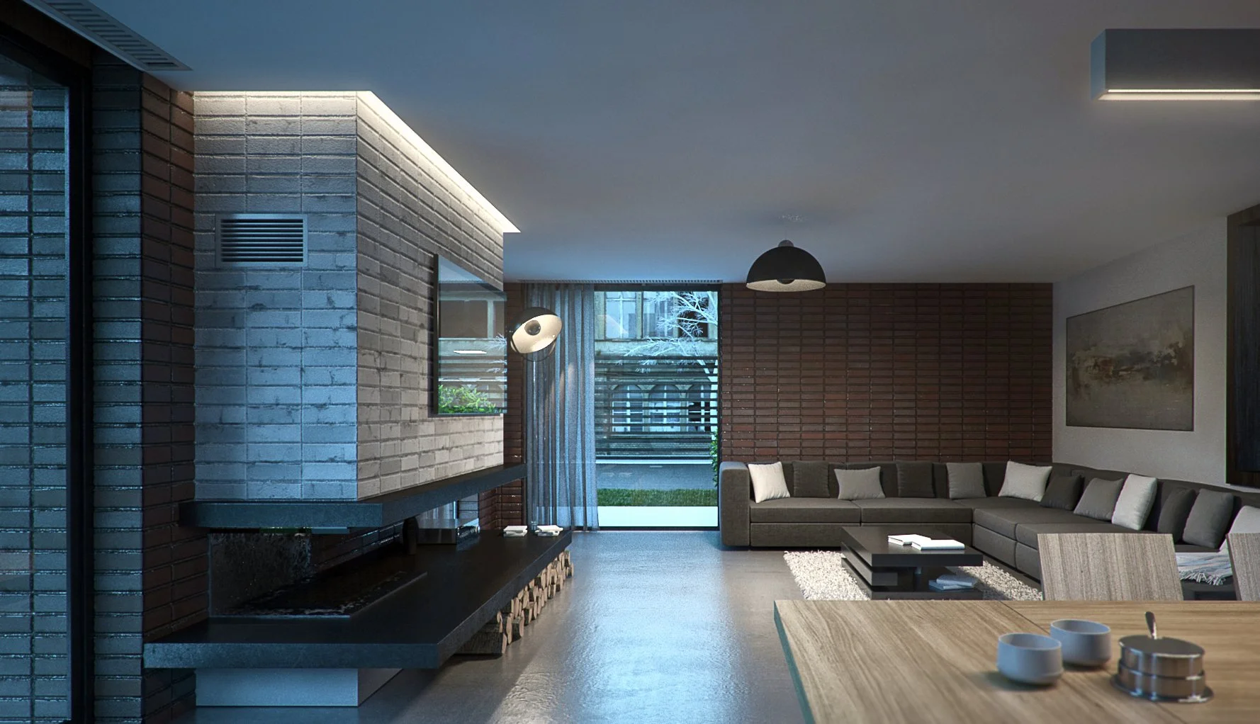 Modern living room with a large gray sectional sofa, brick wall, and a fireplace, with a view of the backyard through glass doors.