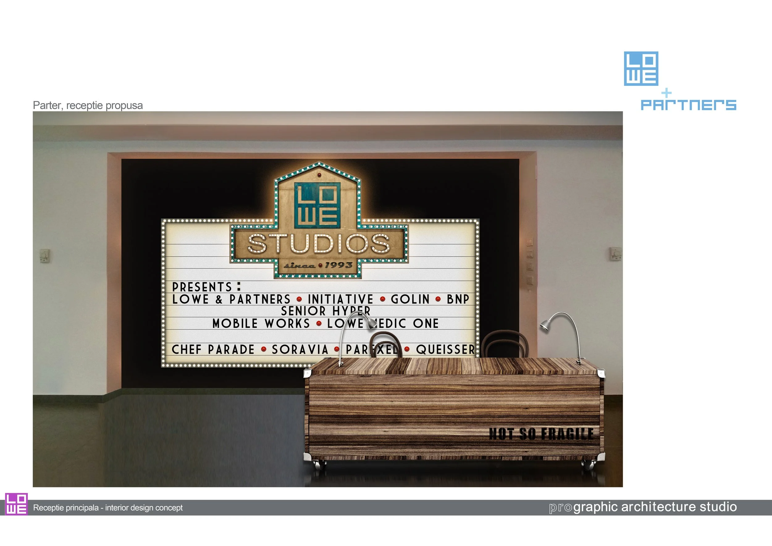 Interior reception area with a large illuminated sign displaying 'LOWE STUDIOS since 1993' and a wooden table with a sink in front, that has the words 'NOT SO FRAGILE' on it.