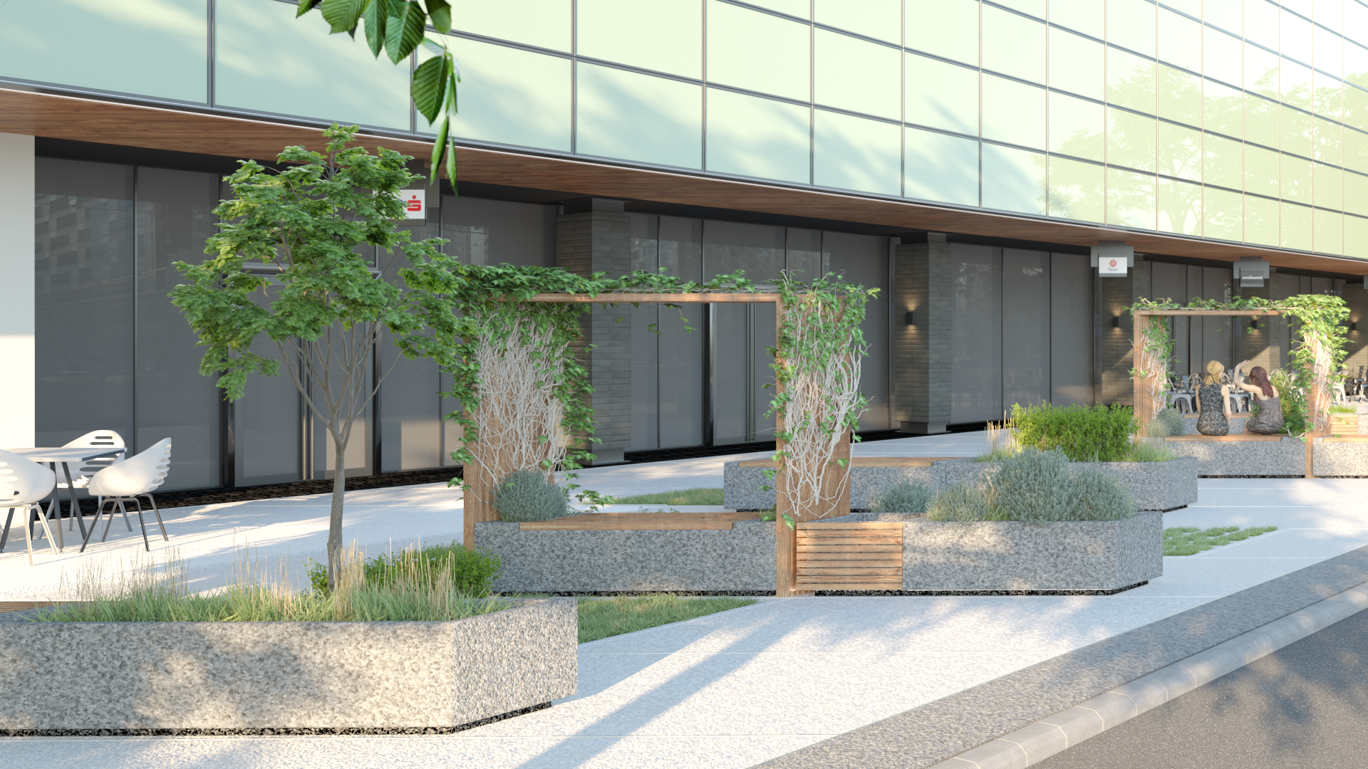 Modern outdoor patio with seating area and landscaping in front of a glass-fronted building.