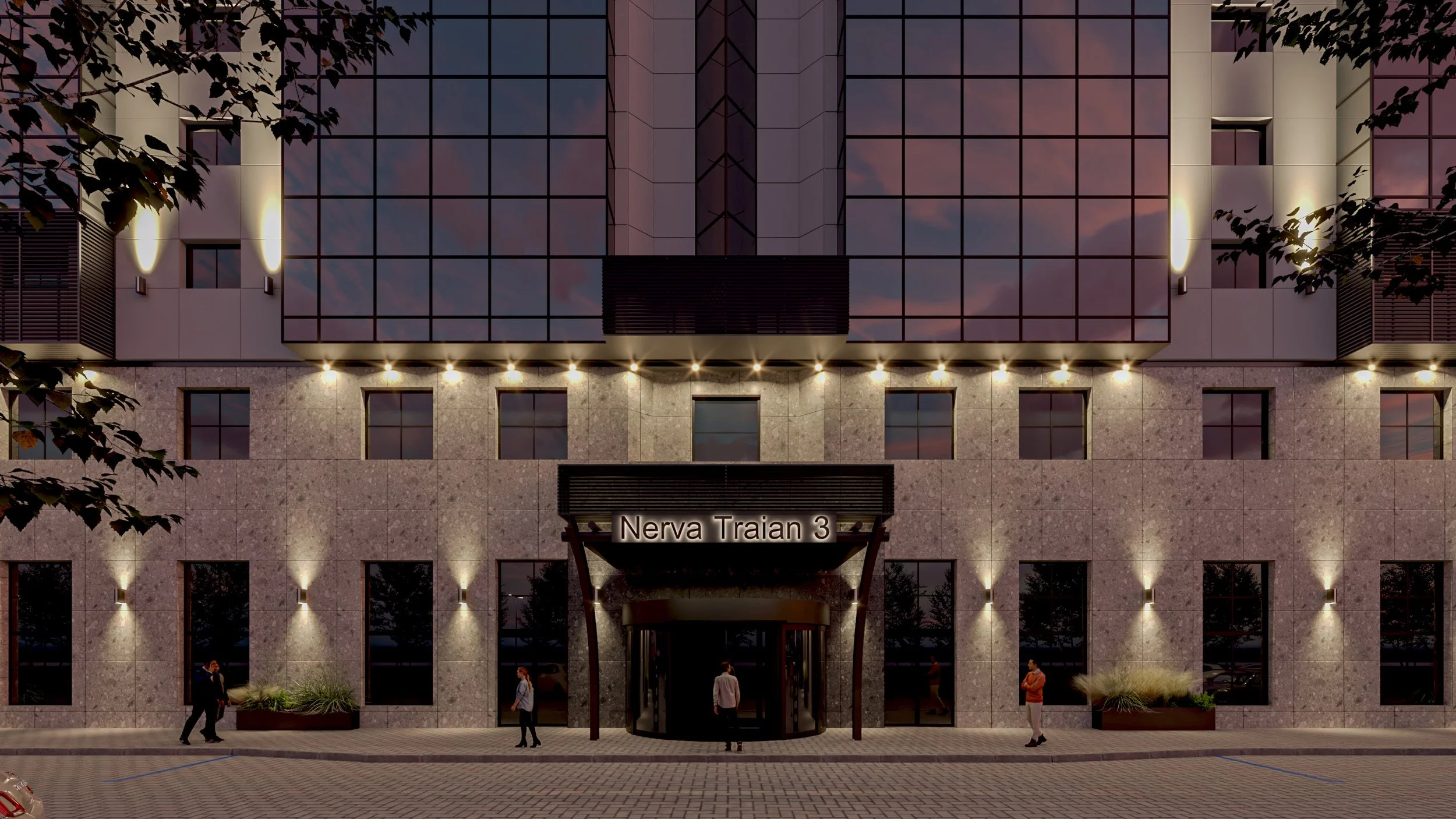 Modern building entrance with a sign that reads 'Nerva Traian 3', illuminated wall lights, glass doors, and several people walking or standing outside in a paved area, with trees partially visible on the sides, during dusk.