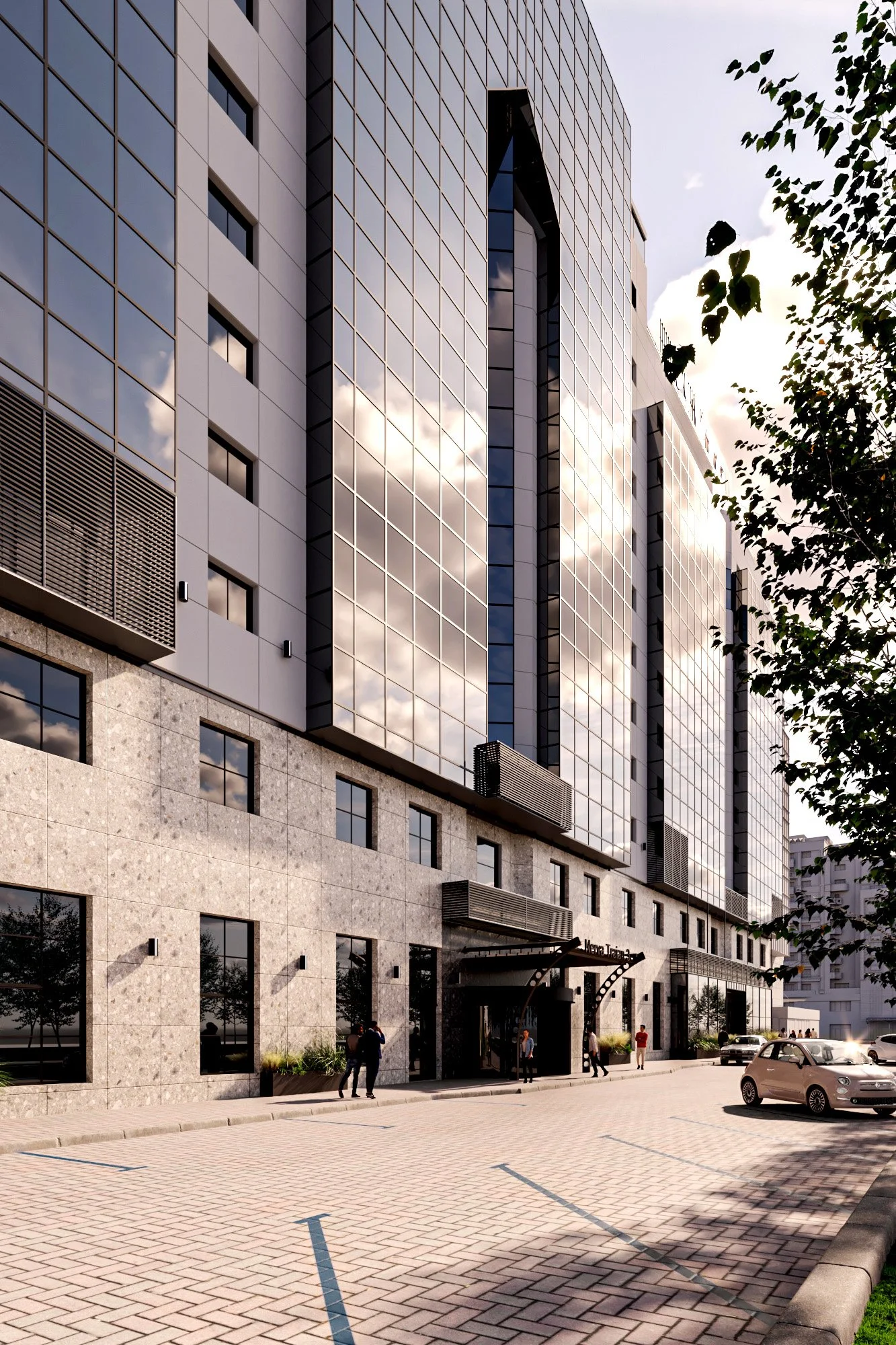 Modern multi-story building with reflective glass windows, a stone facade on the lower level, and a parking lot with a few cars and pedestrians.
