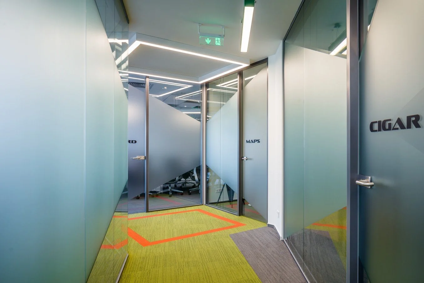 Modern office corridor with frosted glass doors labeled '3RD,' 'MAPS,' and 'CIGAR,' and a colorful yellow and gray carpet.