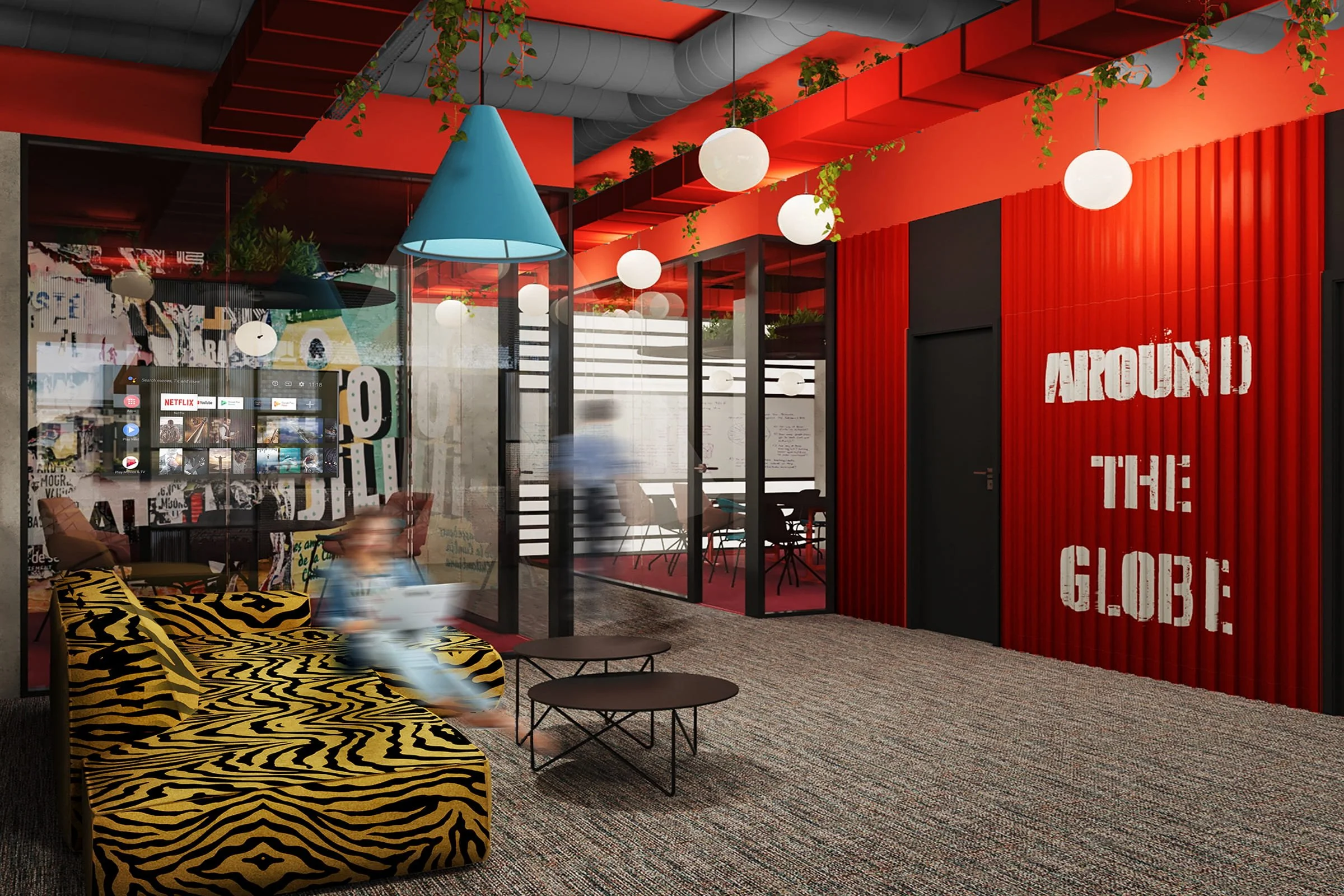 Interior of a modern office with red walls, glass partitions, hanging round lights, a patterned zebra print couch, and a person blurred from motion walking through the space. The wall features graffiti-style text reading 'AROUND THE GLOBE'.