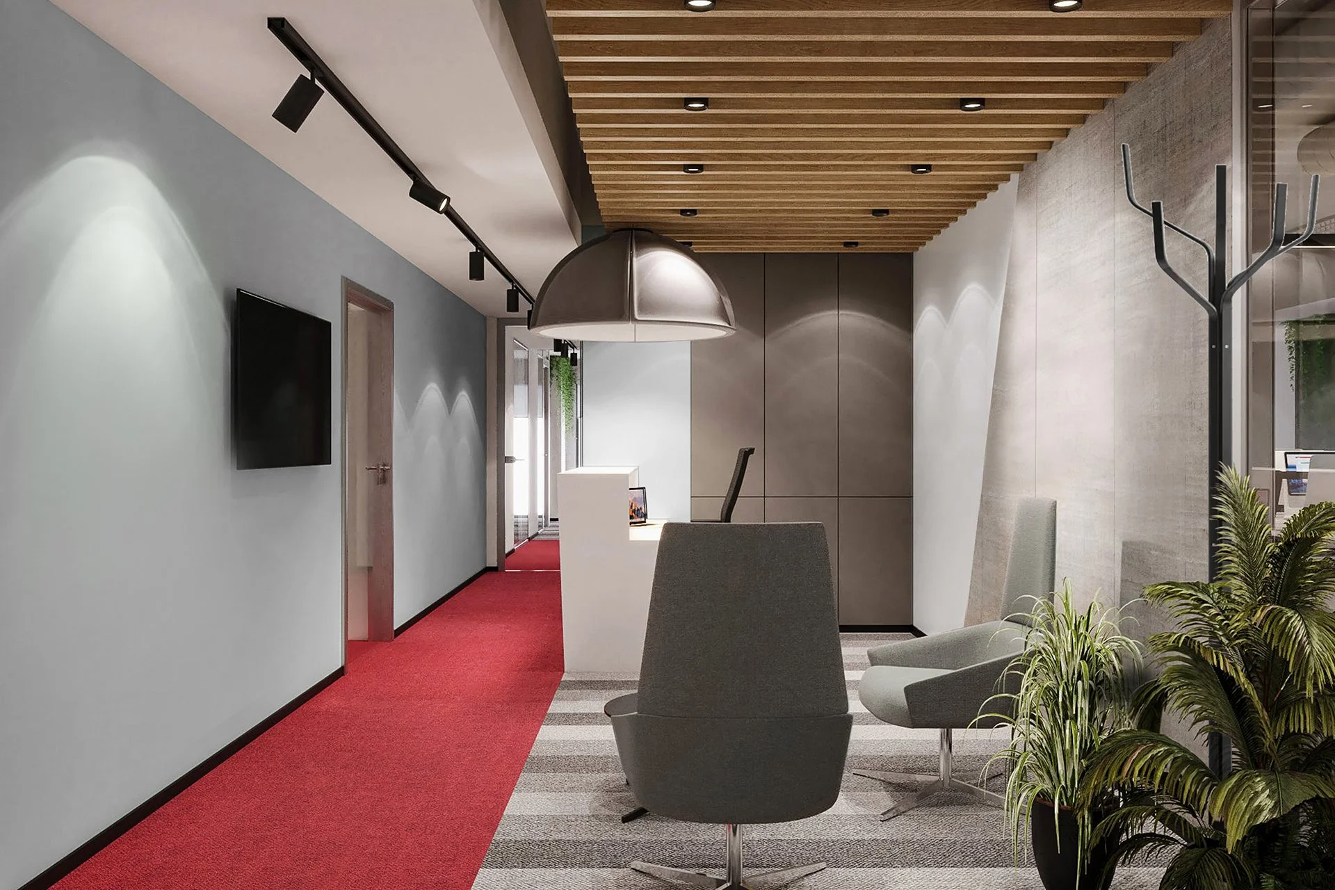 Modern office reception area with gray chairs, plants, a red carpet, and a wall-mounted TV.