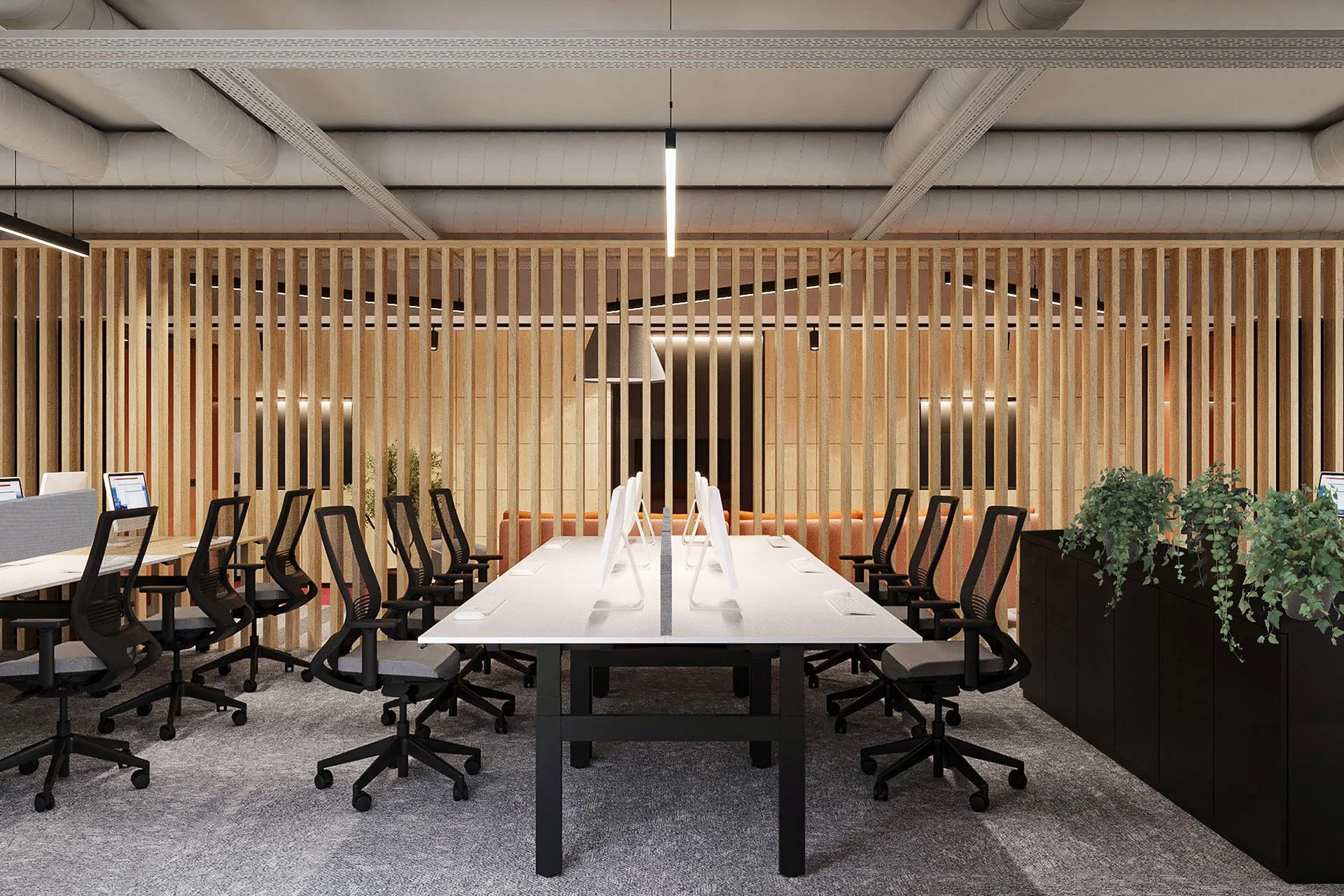 Modern office conference room with a long white table, black office chairs, and desktop computers; decorated with a wooden slat partition and green plants.