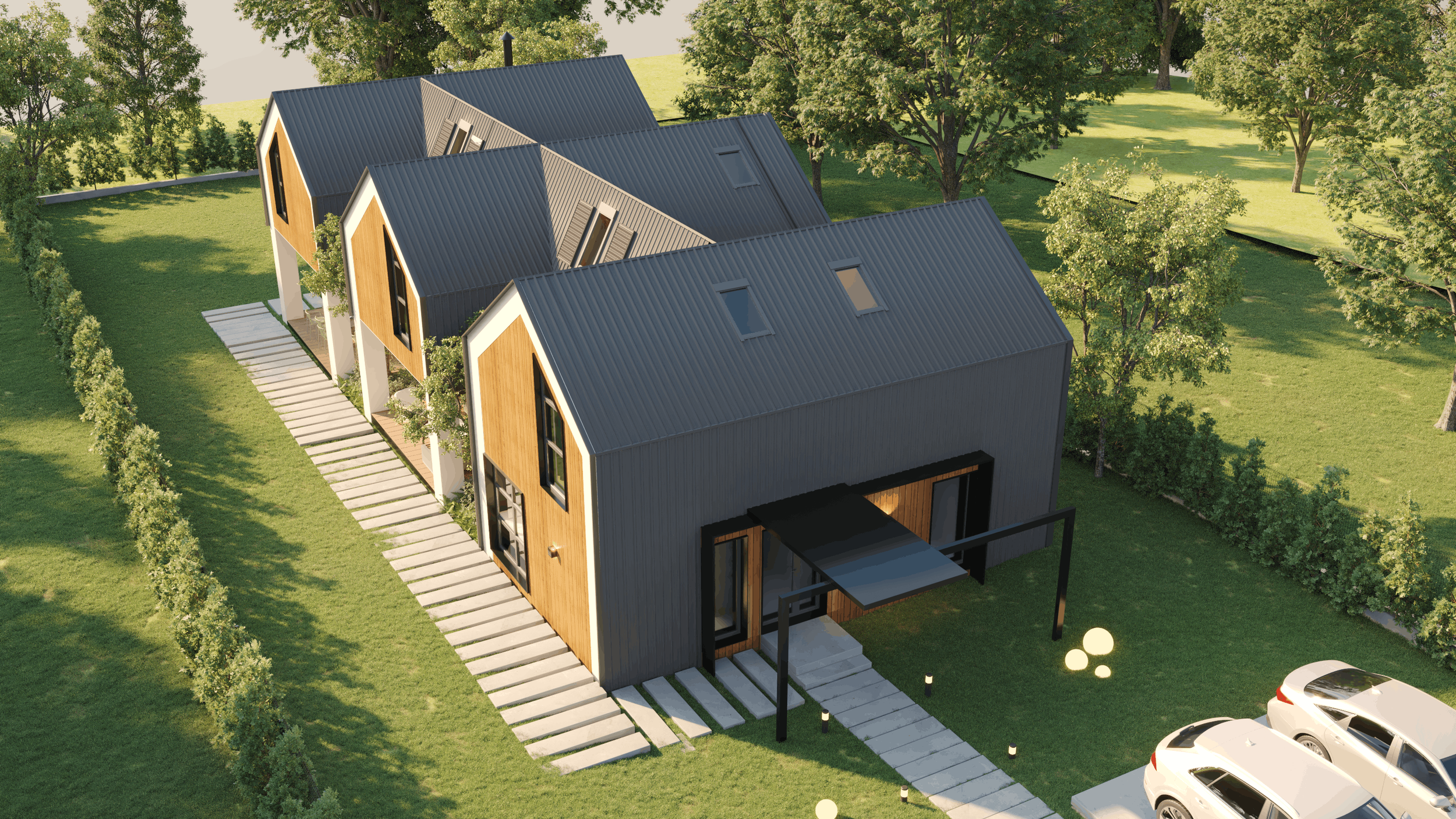 A modern residential building with multiple connected units, featuring black metal roofs, wooden exterior walls, large windows, and outdoor pathways, surrounded by green lawns and trees.