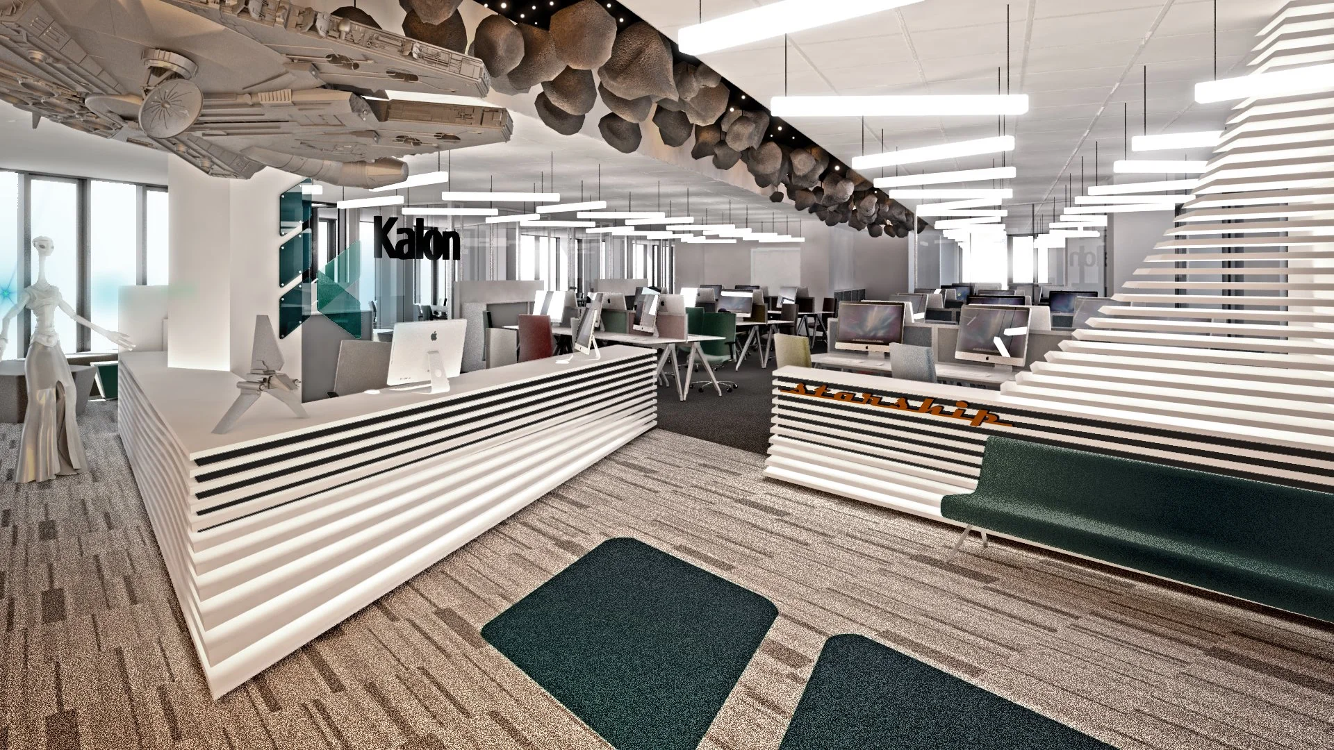 Modern open office space with multiple workstations, computer monitors, and seating areas. Decorative ceiling elements and a large window with natural light. Signage for 'Kalon' and a futuristic spaceship model hanging from the ceiling.