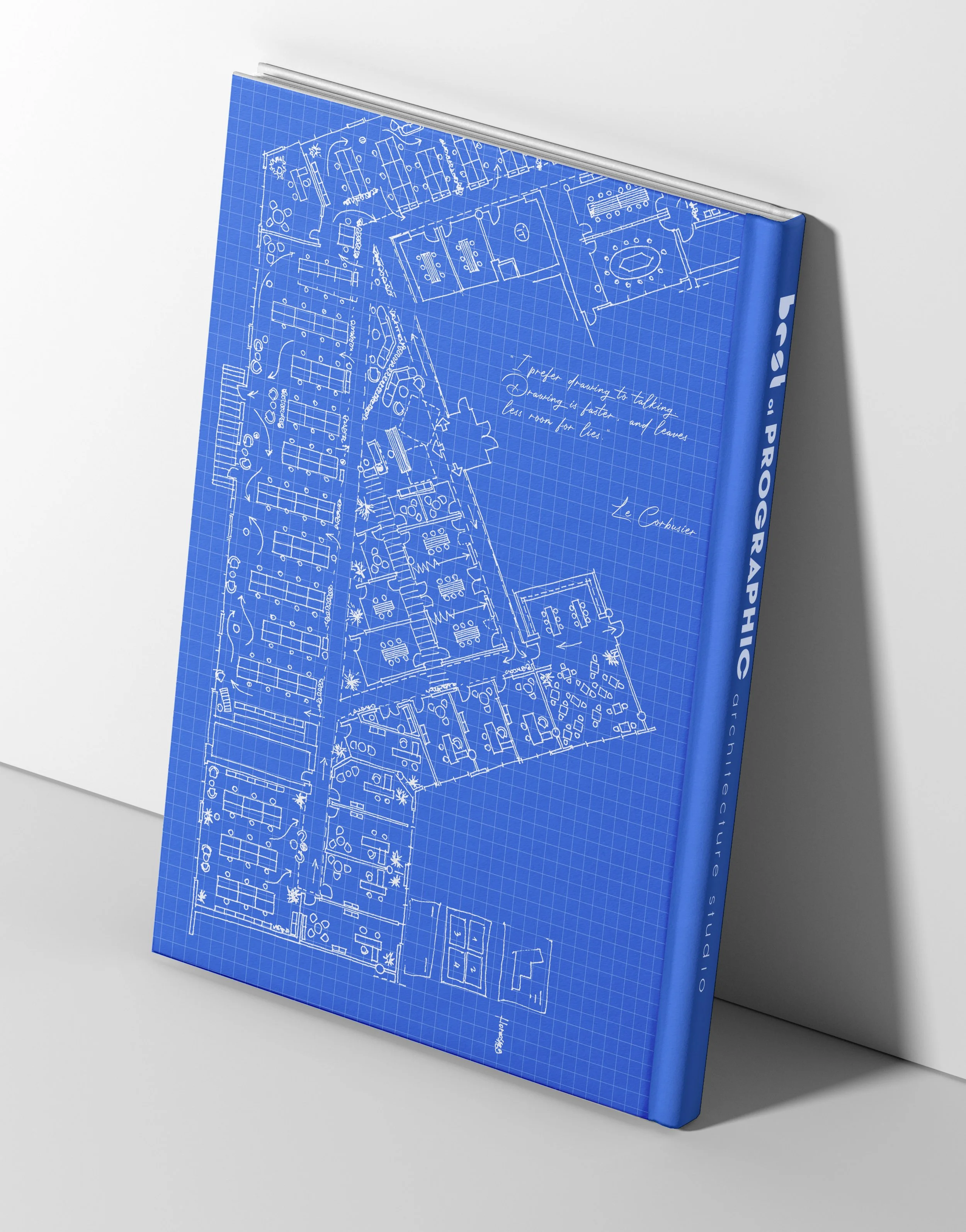 Blueprint of a building layout with handwritten notes and doodles on a blue grid background.