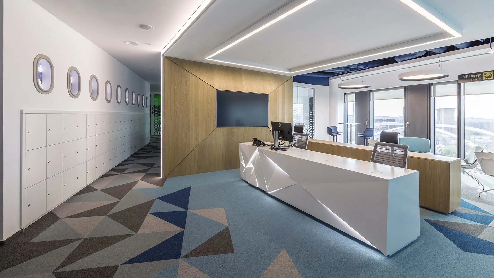 Modern airport lounge with reception desk, large window view, seating areas, and luggage lockers.