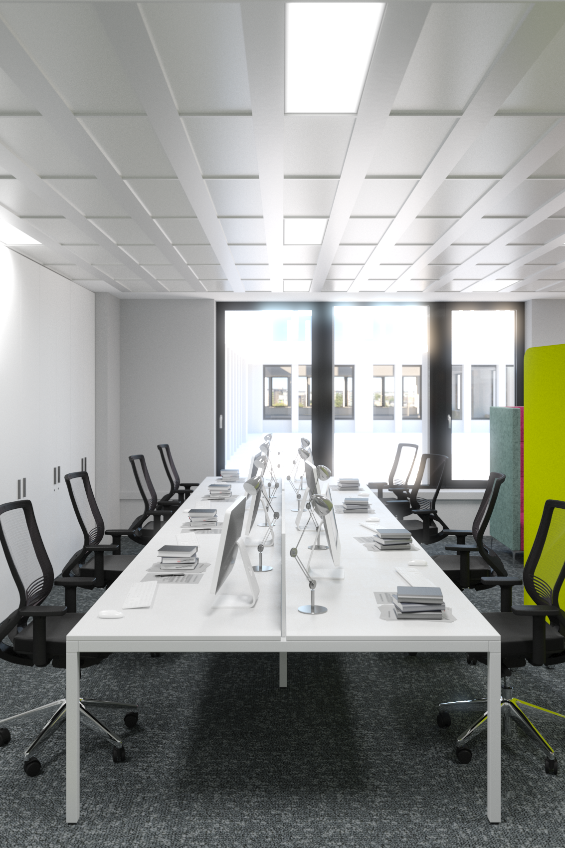 Modern conference room with a long white table, black office chairs, and desktop computers. Large windows at the back let in natural light, and colorful partitions are on the side.