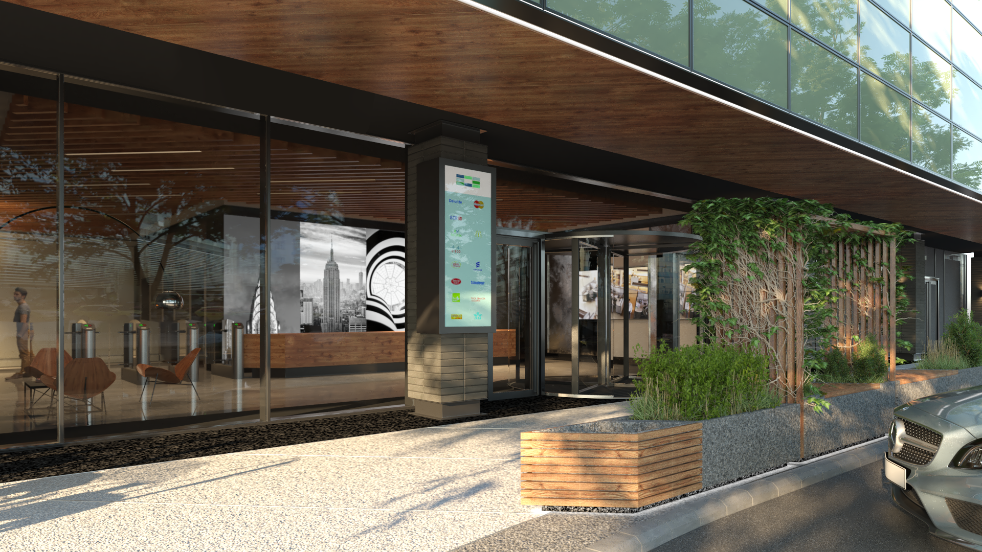 Modern office building with large glass windows, outdoor seating, and greenery, featuring a digital directory near the entrance.