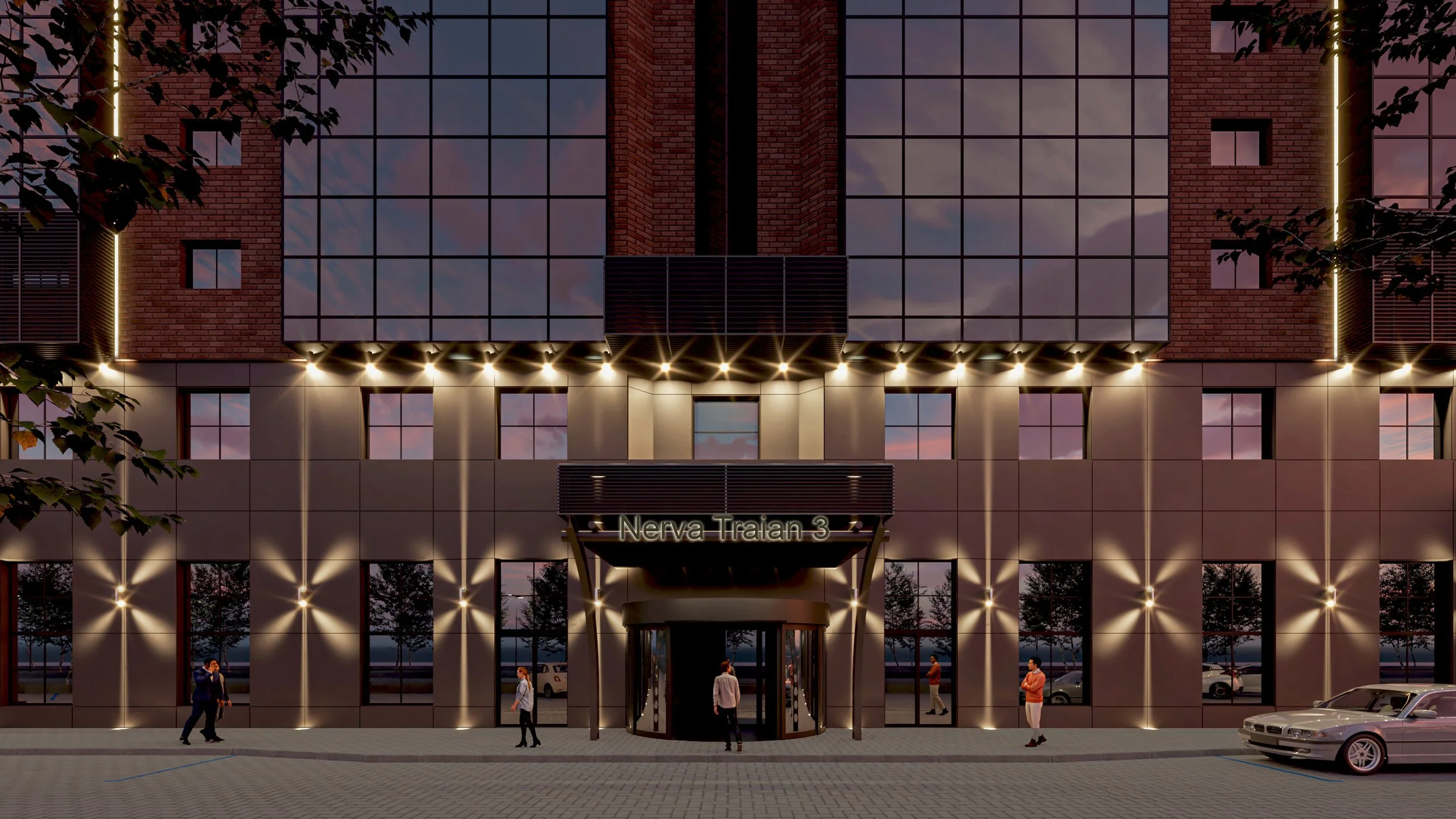 Night view of a modern multi-story building with large glass windows, illuminated by exterior lights, with a sign that reads 'Nerva Traian 3' at the entrance. Several people are walking near the building, and cars are parked nearby, with trees lining the street.