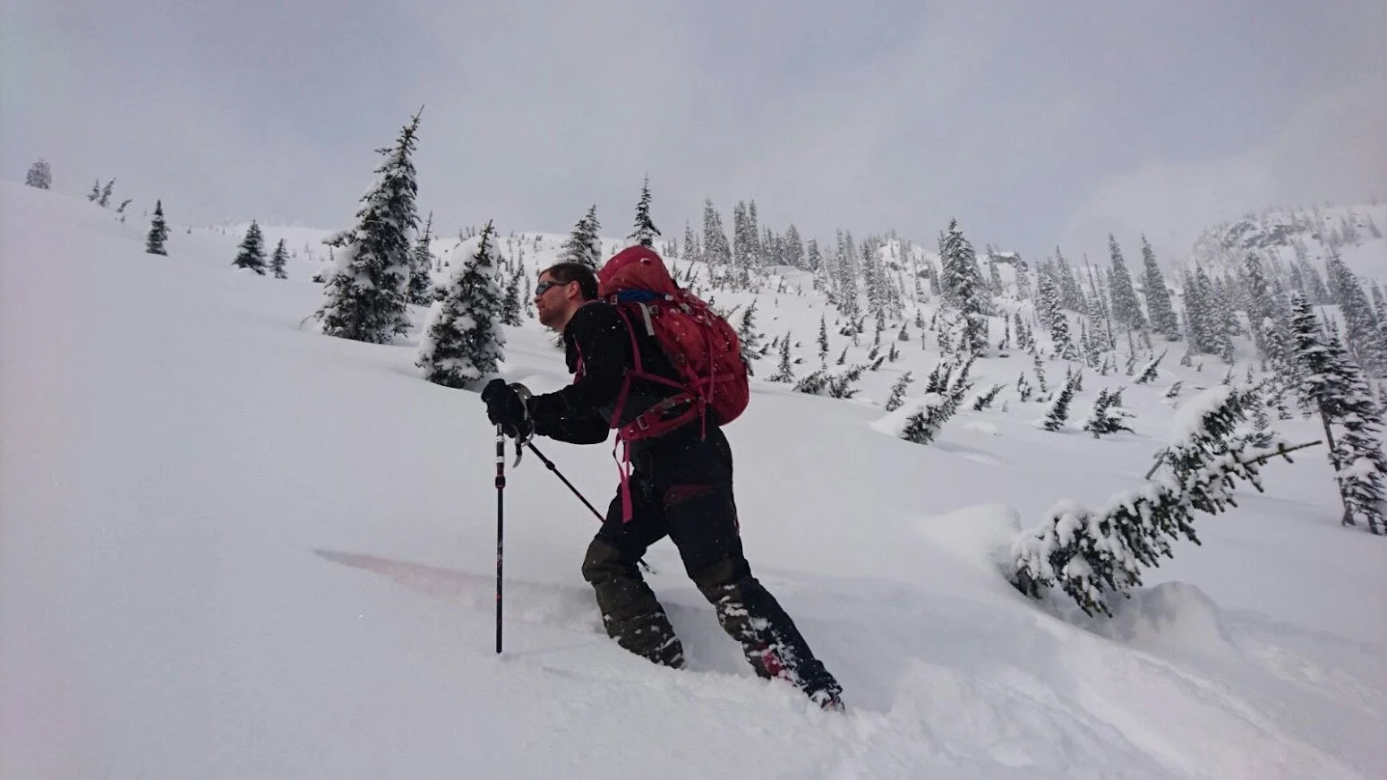 Carlsen på veg opp ein snøtung fjellskråning