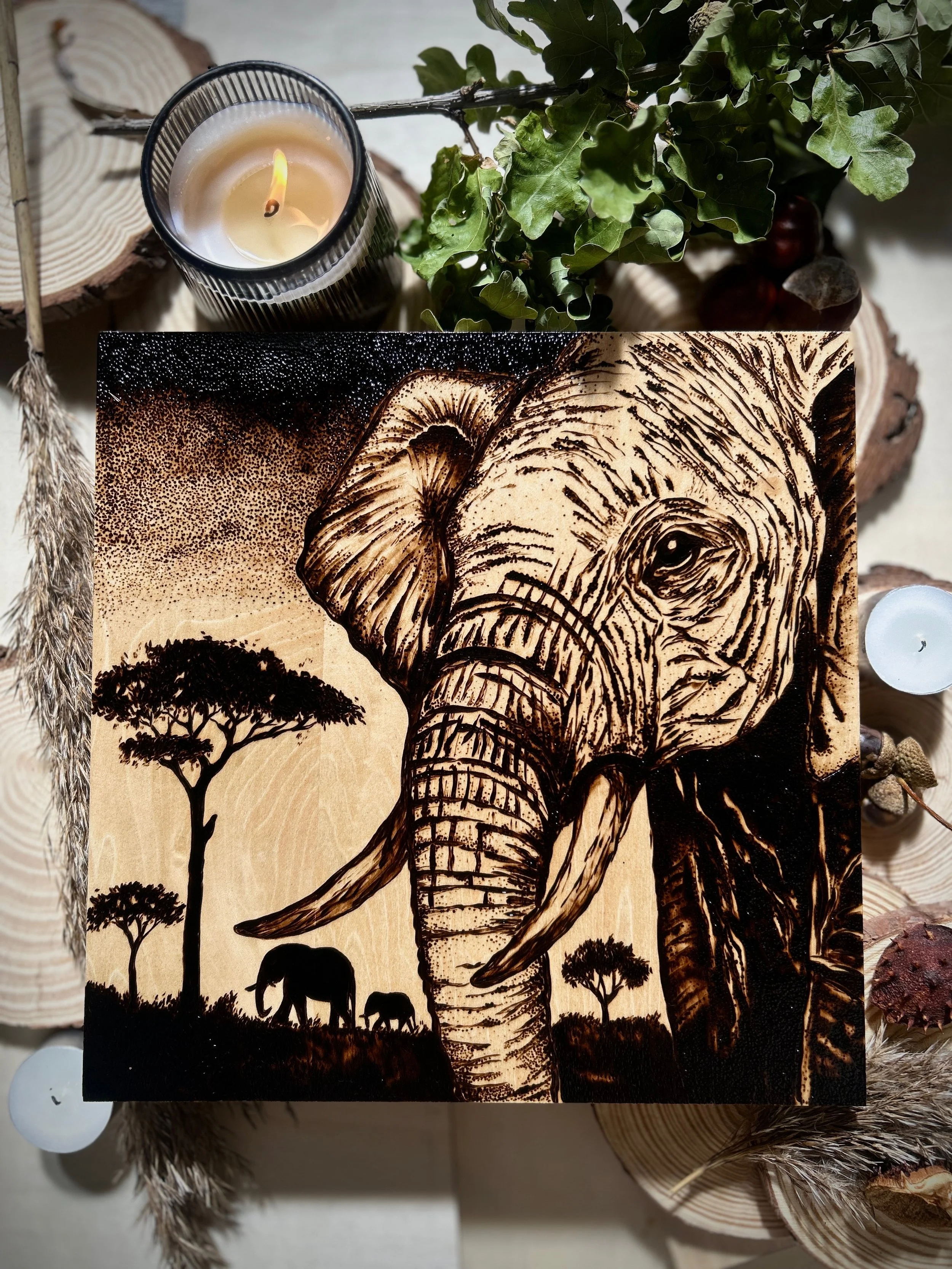 Collection of wood-burned pyrography artworks showcasing handcrafted fantasy art in unique, artisan, one-of-a-kind designs and decor, featuring detailed Savanna Reverie elephant scenes on natural wood