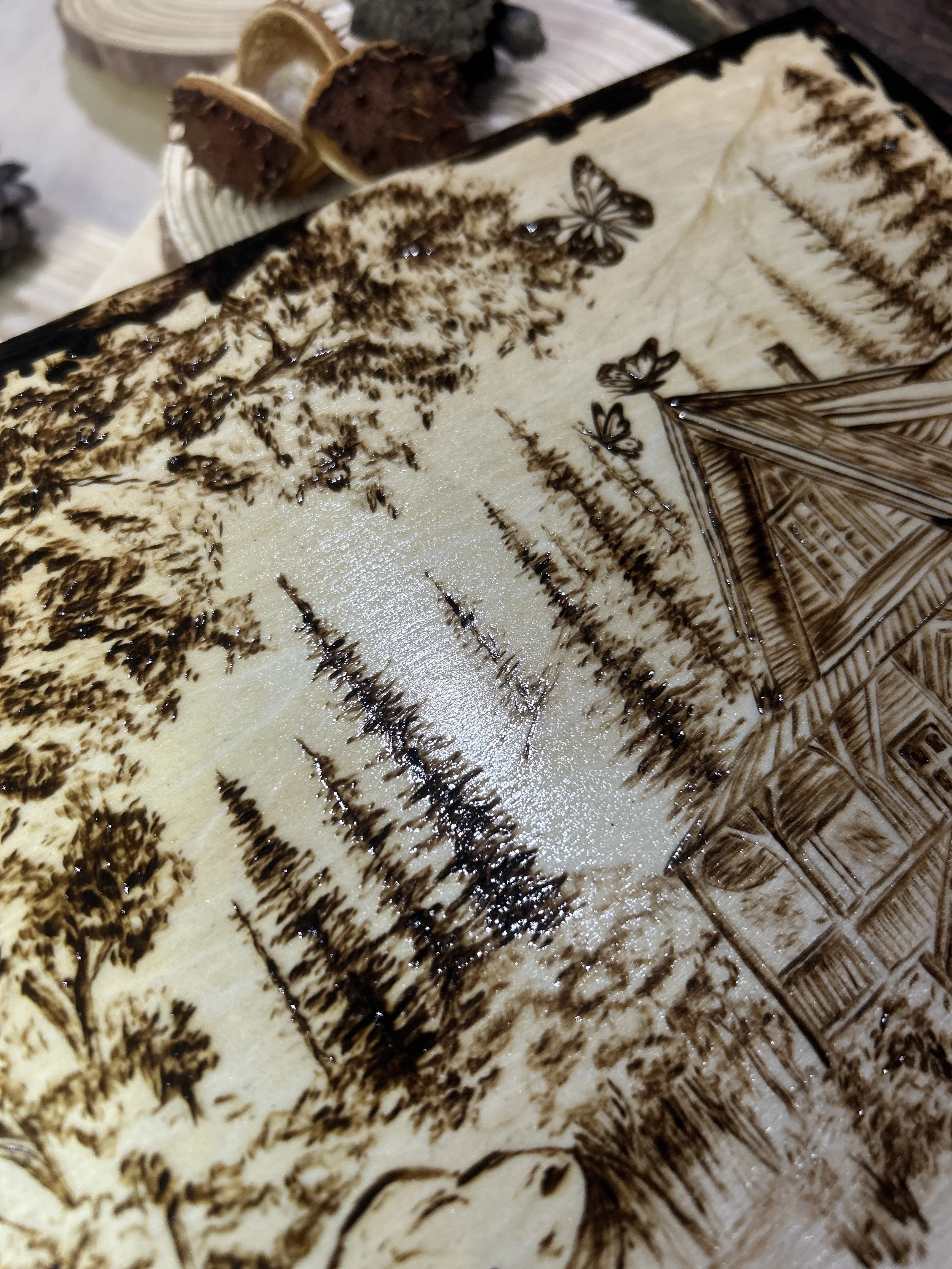 Collection of wood-burned pyrography artworks showcasing handcrafted fantasy art in unique, artisan, one-of-a-kind designs and decor, featuring detailed Dusk Hollow scenes on natural wood