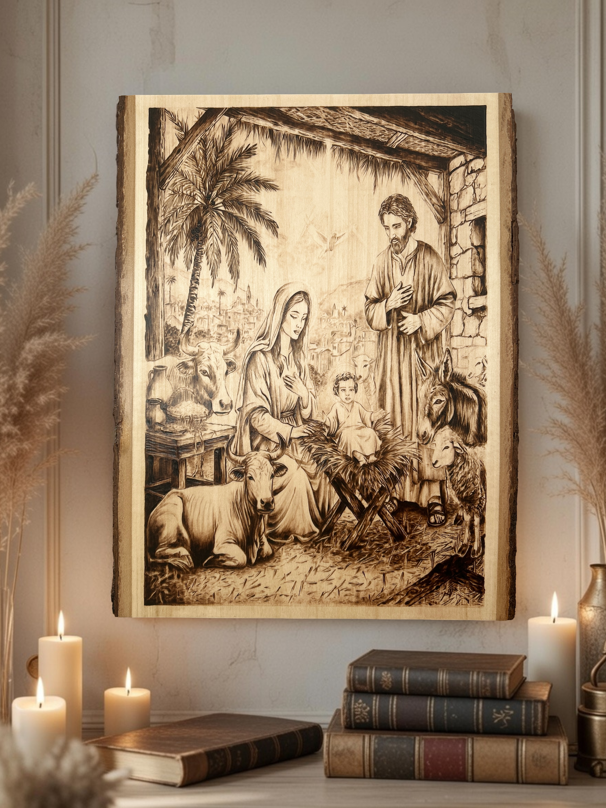 Intricate wood-burned Nativity scene featuring Mary, Joseph, and Baby Jesus in a stable with a donkey, ox, and lamb, displayed as home decor with candles and books