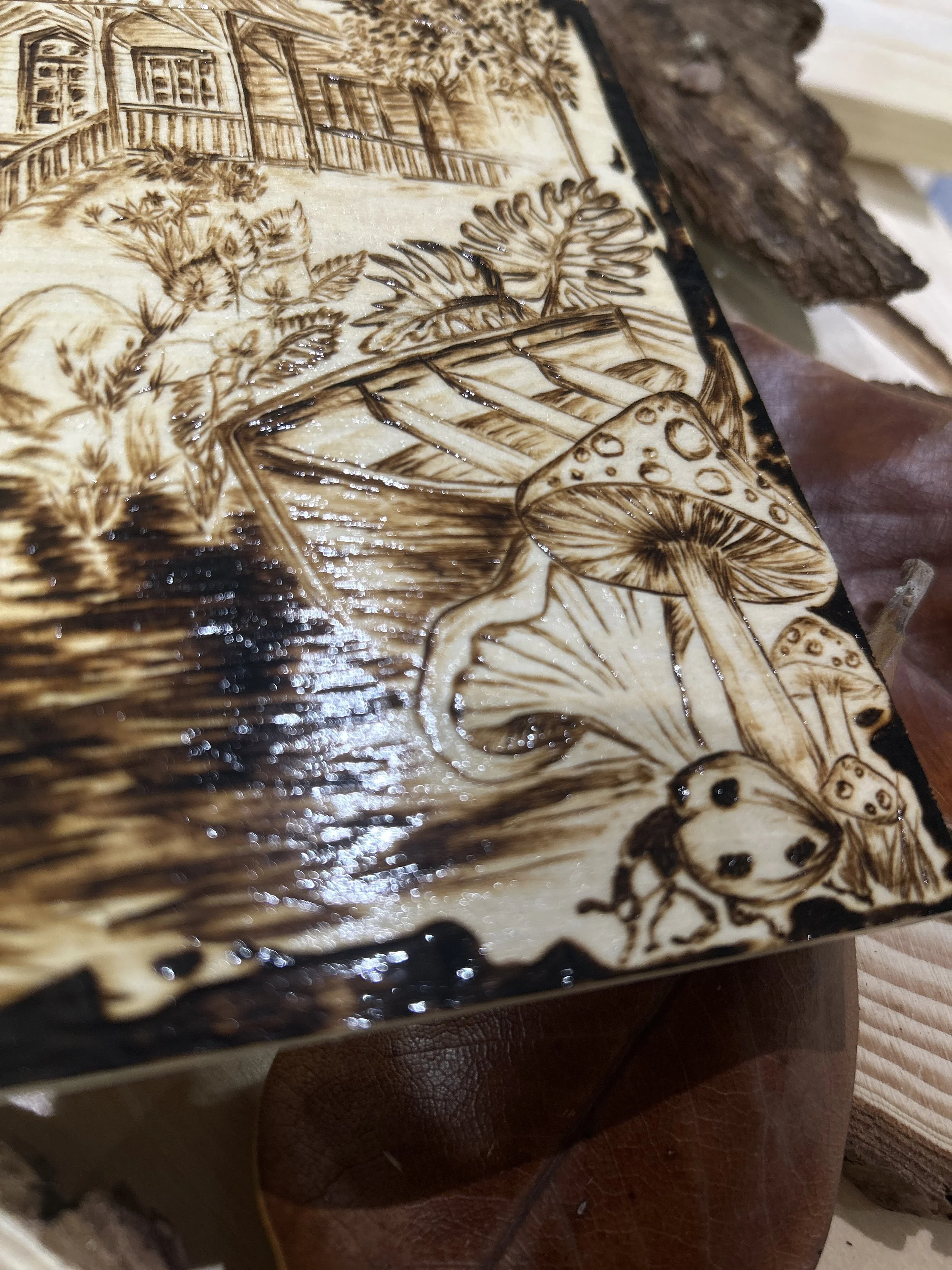 Collection of wood-burned pyrography artworks showcasing handcrafted fantasy art in unique, artisan, one-of-a-kind designs and decor, featuring detailed Dusk Hollow scenes on natural wood