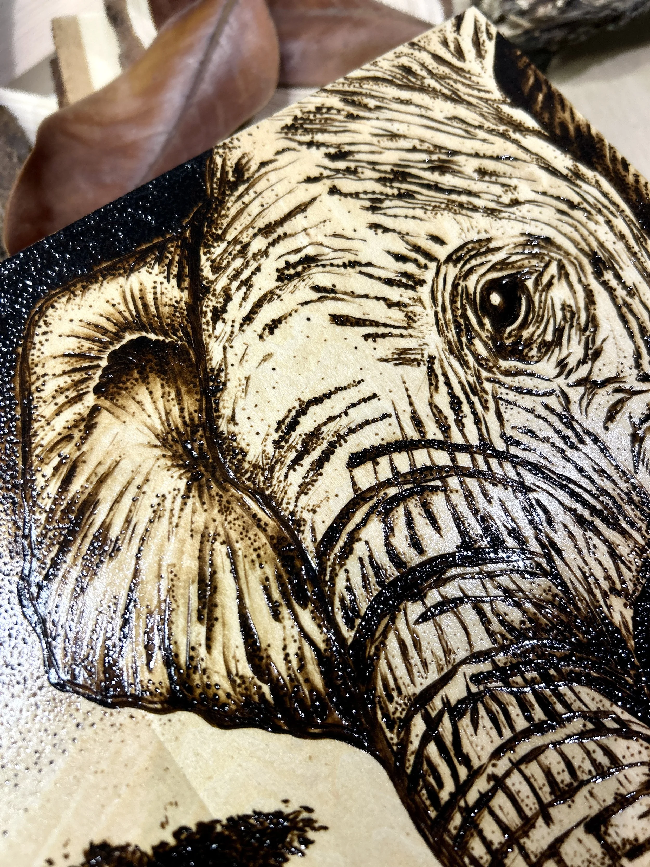 Collection of wood-burned pyrography artworks showcasing handcrafted fantasy art in unique, artisan, one-of-a-kind designs and decor, featuring detailed Savanna Reverie elephant scenes on natural wood