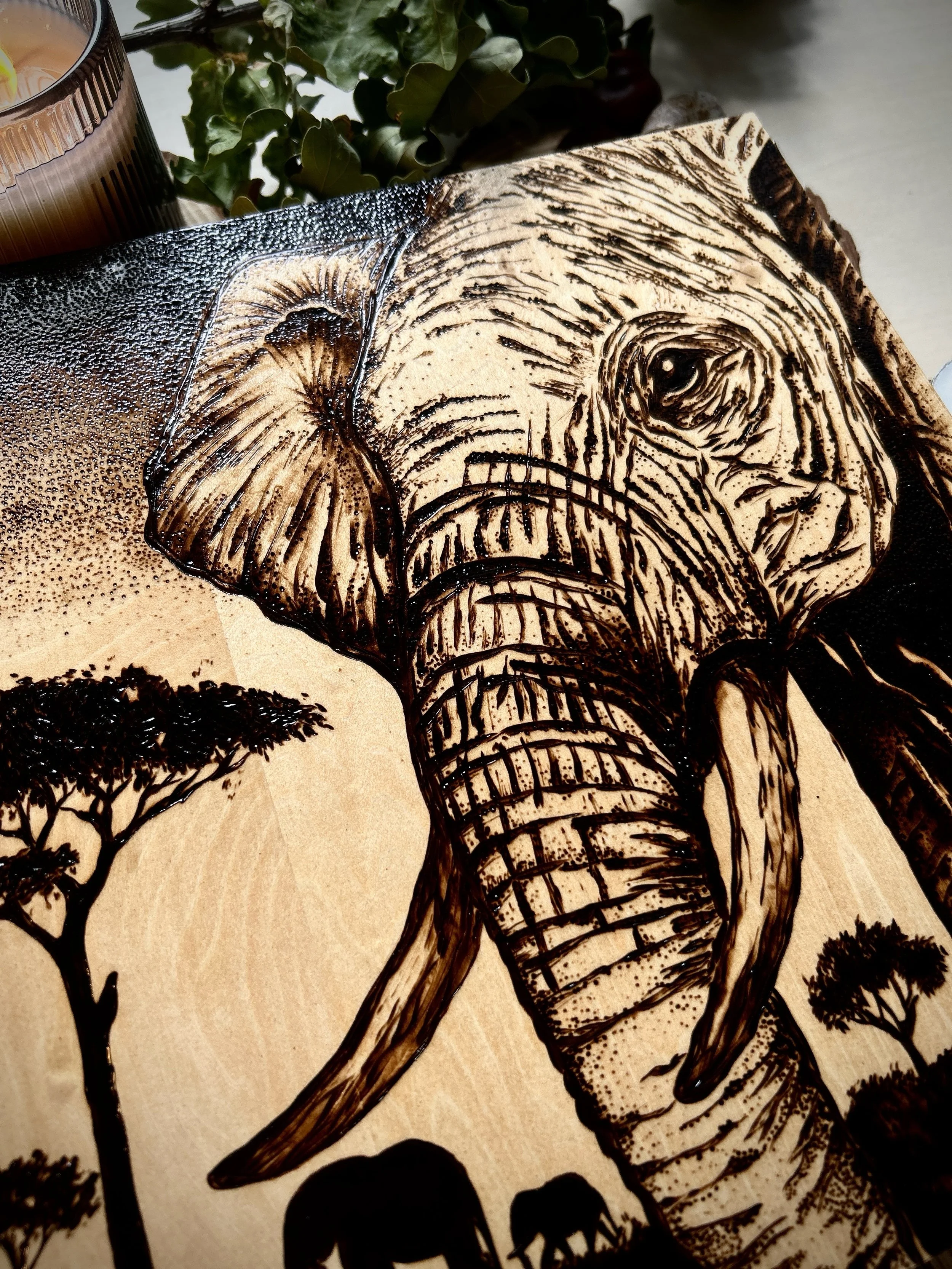Collection of wood-burned pyrography artworks showcasing handcrafted fantasy art in unique, artisan, one-of-a-kind designs and decor, featuring detailed Savanna Reverie elephant scenes on natural wood