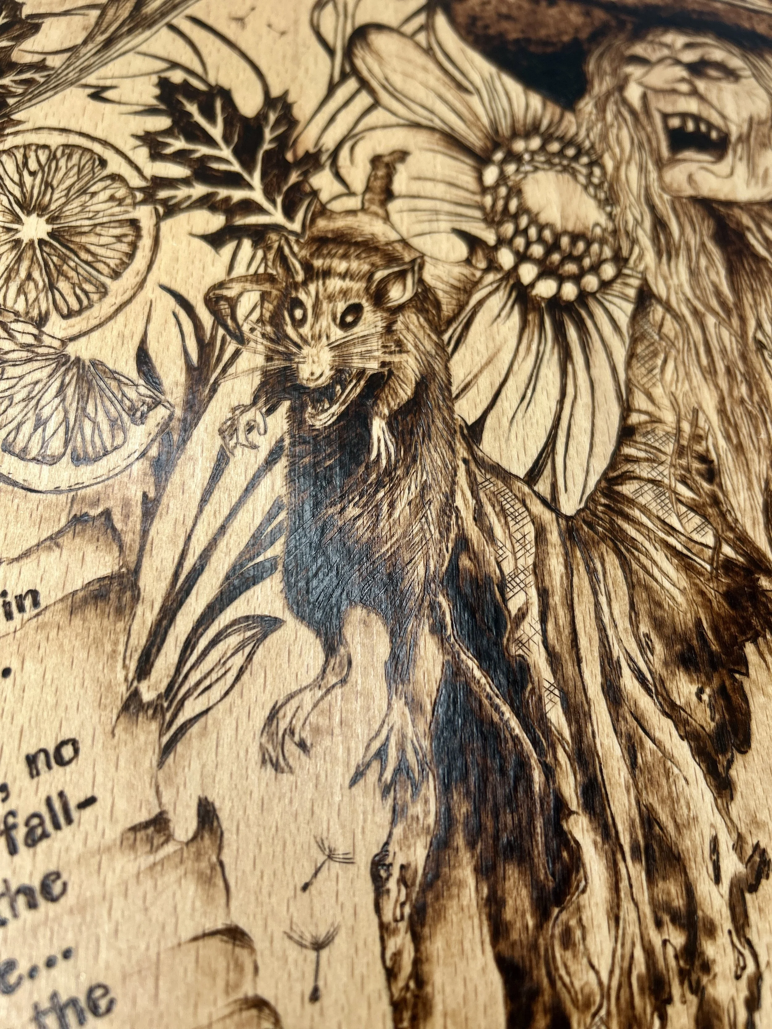 Vertical close-up of the witch holding a black cat, showing the detailed fur texture and the surrounding floral border.