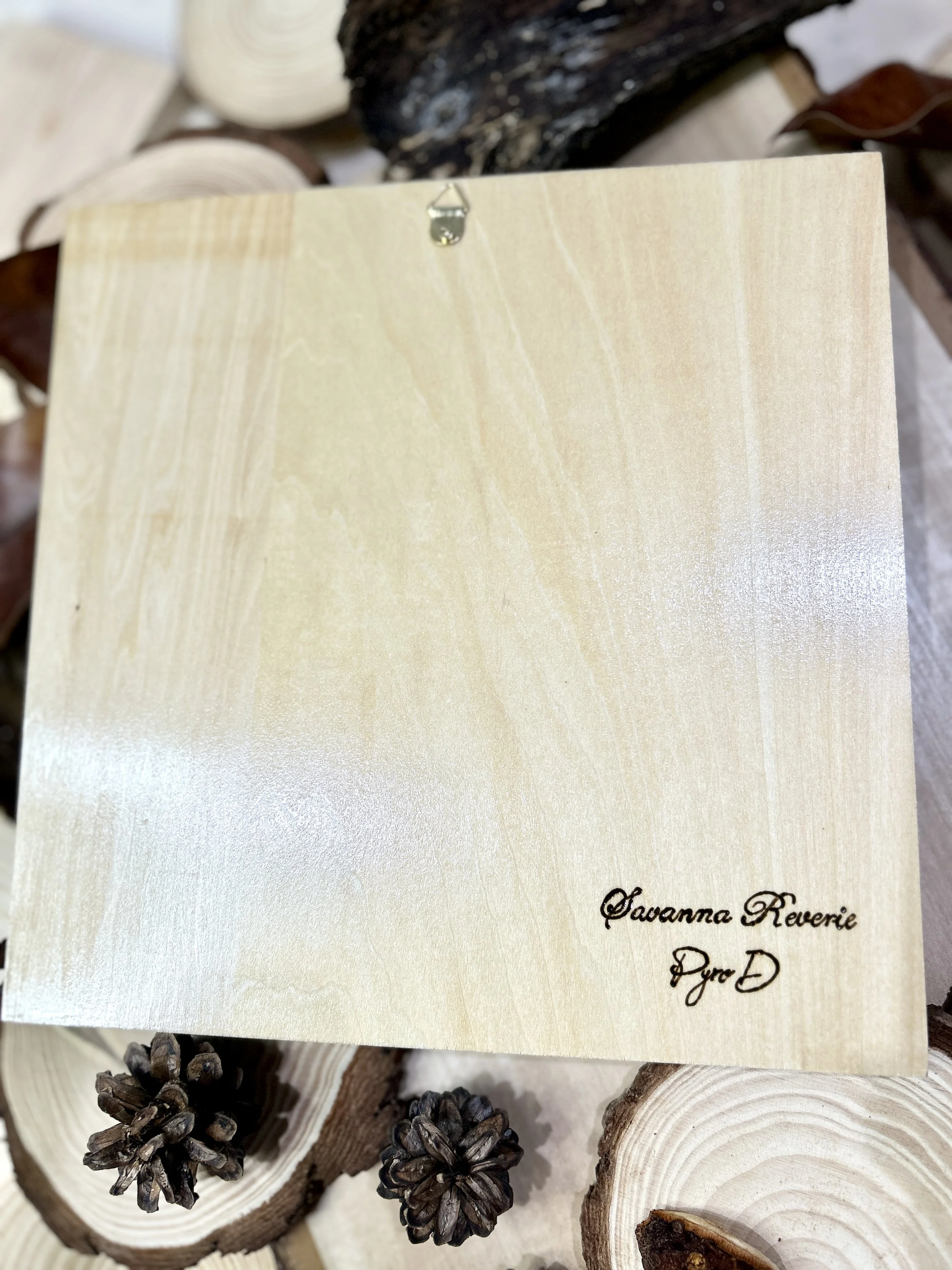 Collection of wood-burned pyrography artworks showcasing handcrafted fantasy art in unique, artisan, one-of-a-kind designs and decor, featuring detailed Savanna Reverie elephant scenes on natural wood