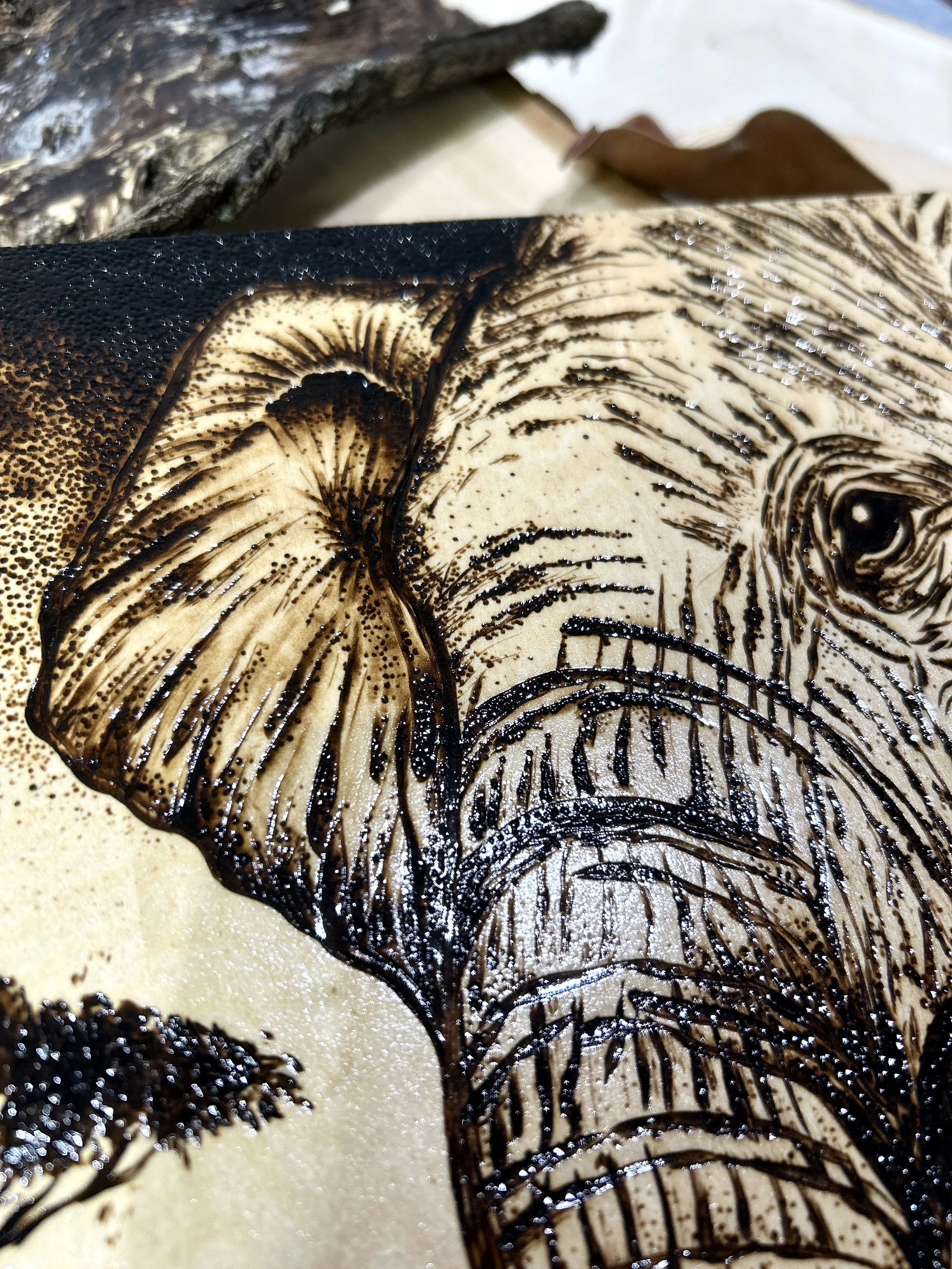 Collection of wood-burned pyrography artworks showcasing handcrafted fantasy art in unique, artisan, one-of-a-kind designs and decor, featuring detailed Savanna Reverie elephant scenes on natural wood