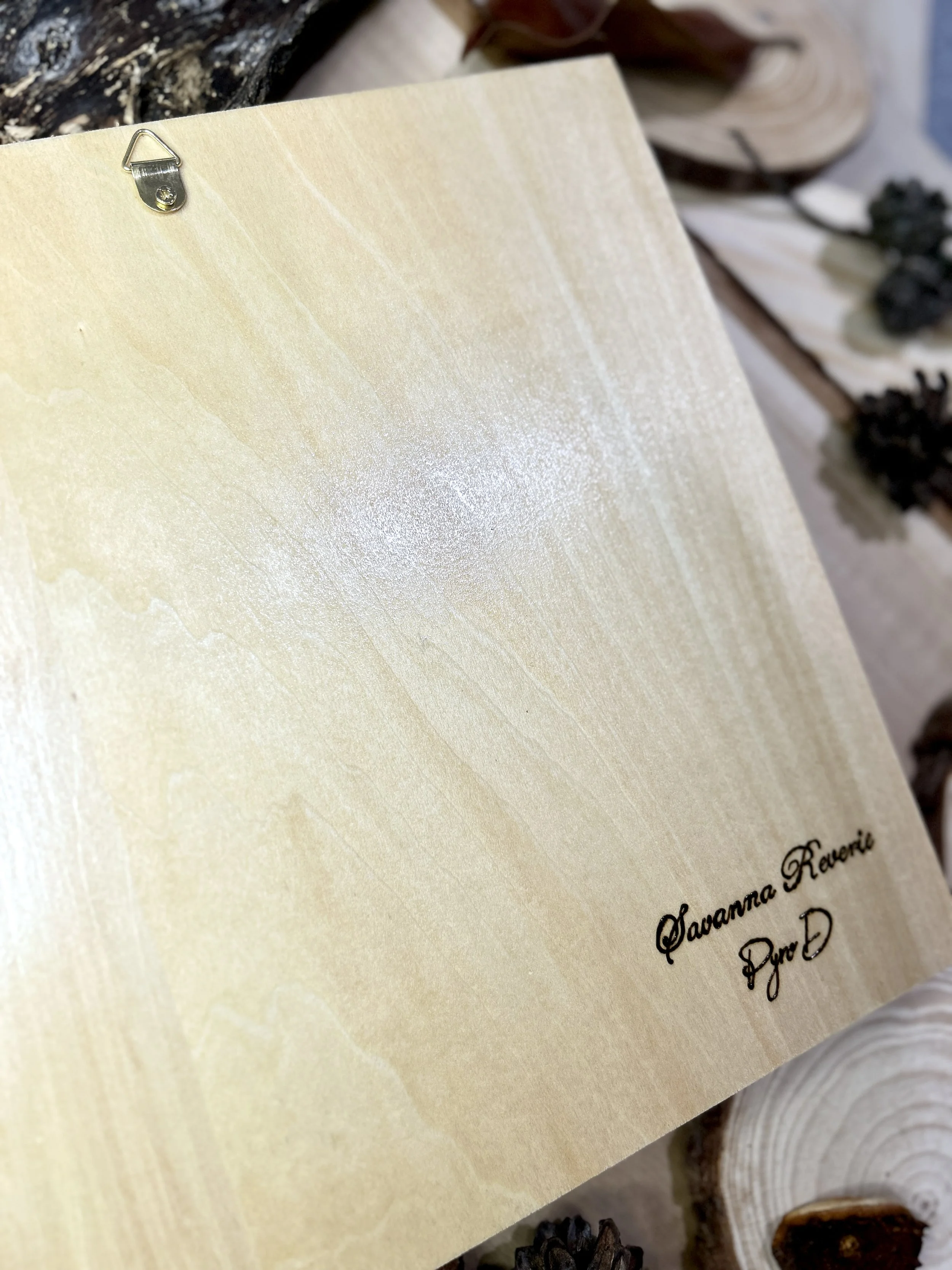Collection of wood-burned pyrography artworks showcasing handcrafted fantasy art in unique, artisan, one-of-a-kind designs and decor, featuring detailed Savanna Reverie elephant scenes on natural wood