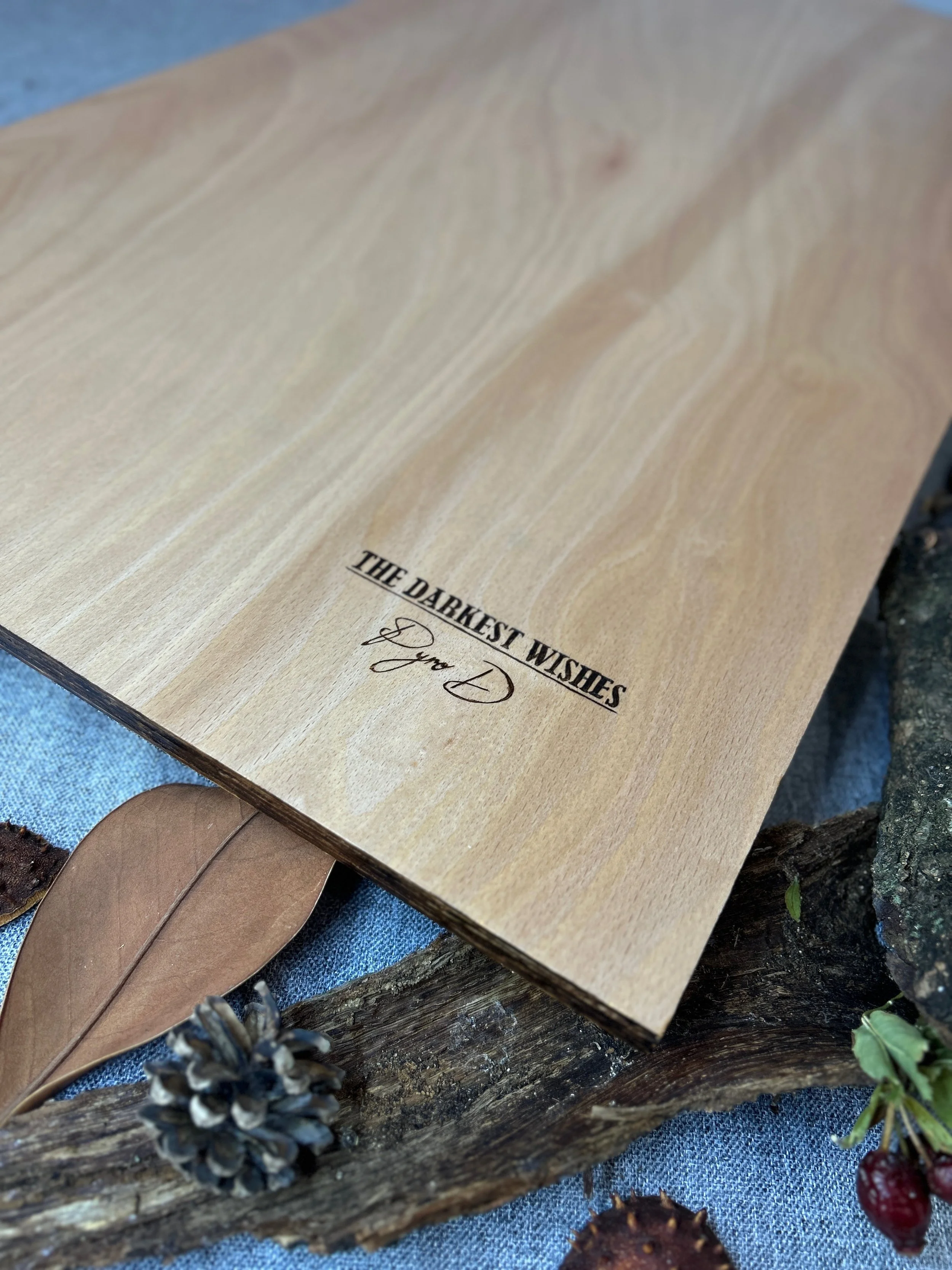Back view of The Darkest Wishes solid hardwood timber, displaying artwork title and Pyro D-Studio’s crafted artist signature