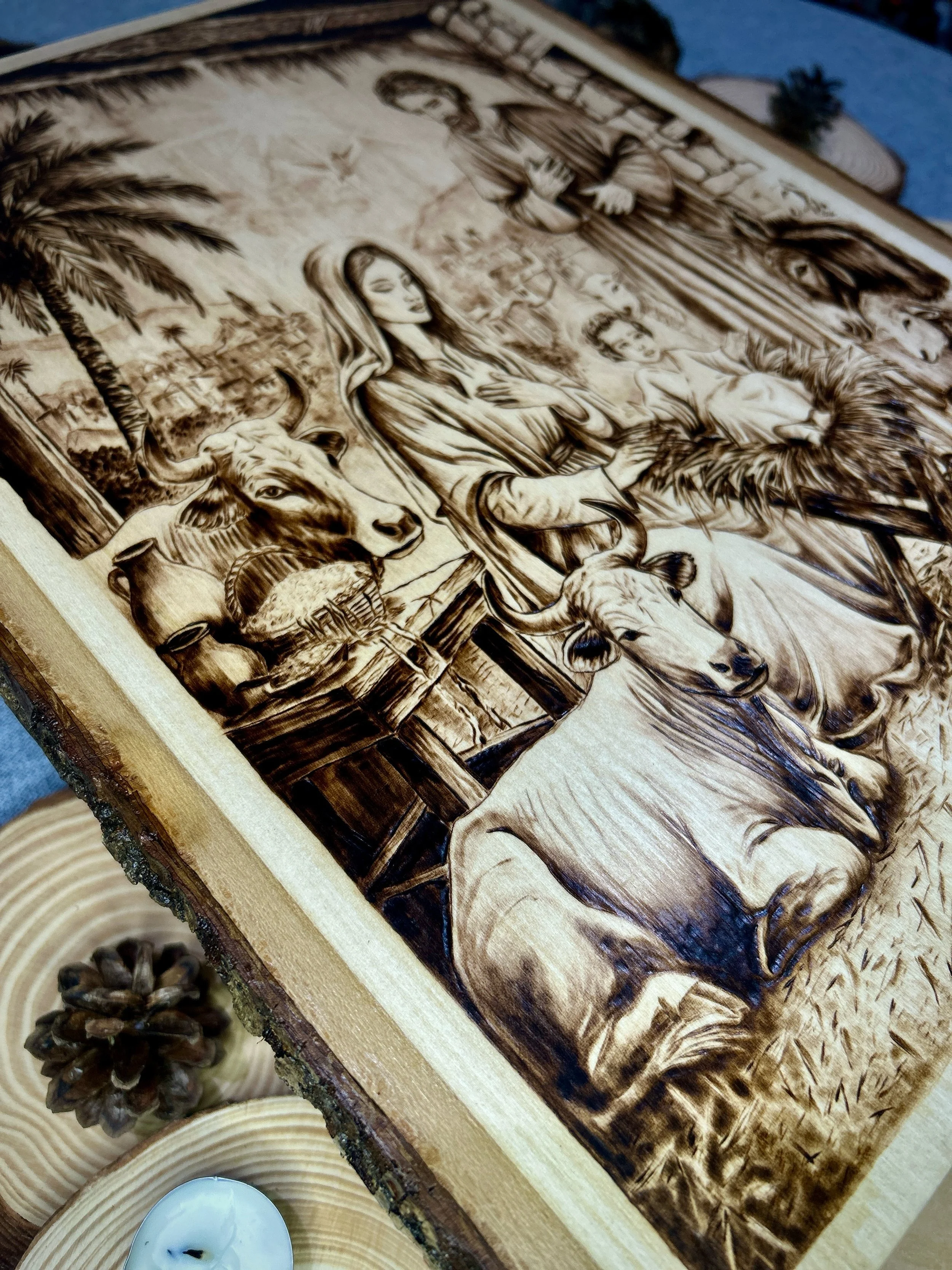 High-angle detail of Stable Of Grace pyrography, showing full scene on solid hardwood