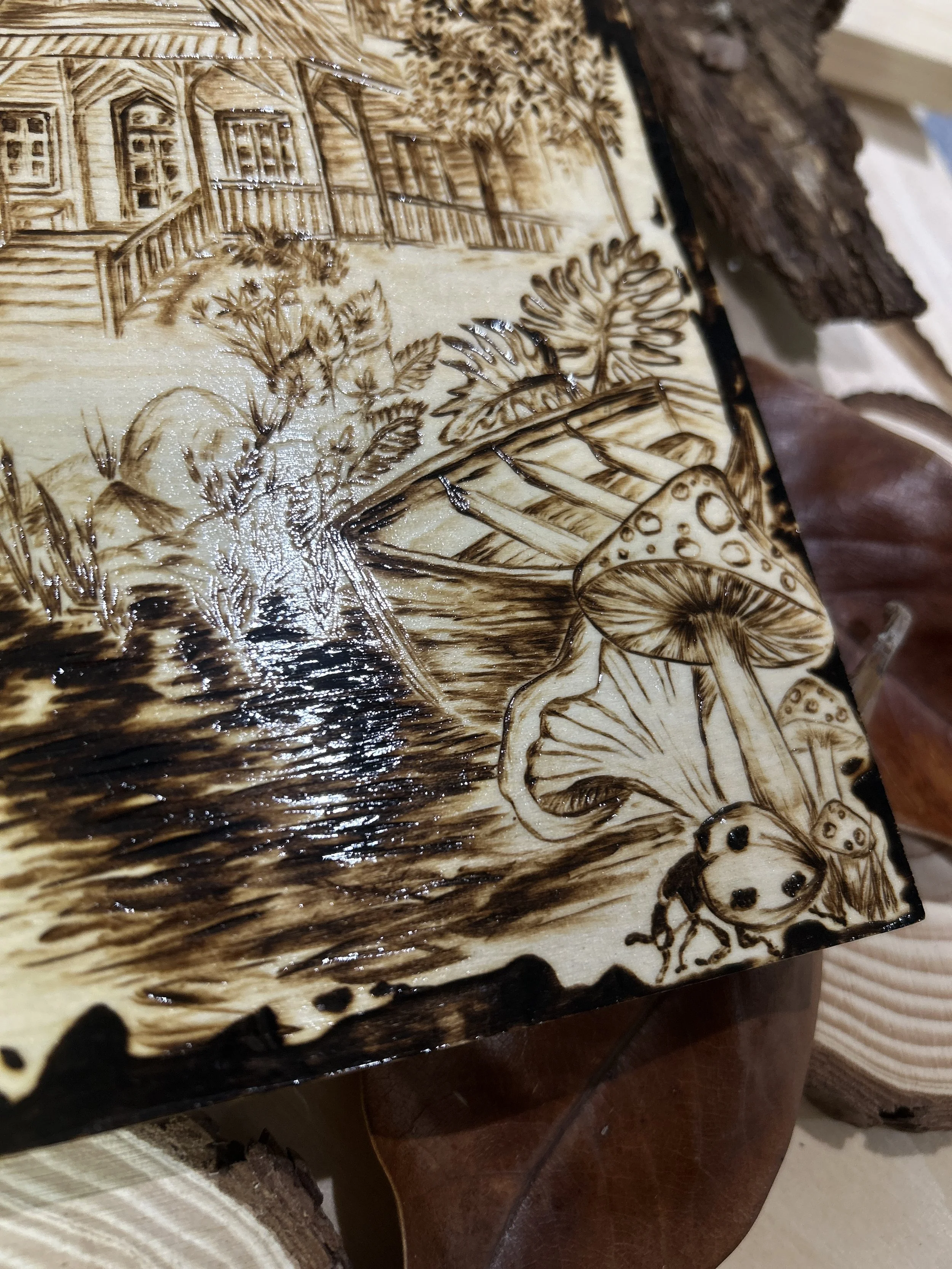 Collection of wood-burned pyrography artworks showcasing handcrafted fantasy art in unique, artisan, one-of-a-kind designs and decor, featuring detailed Dusk Hollow scenes on natural wood