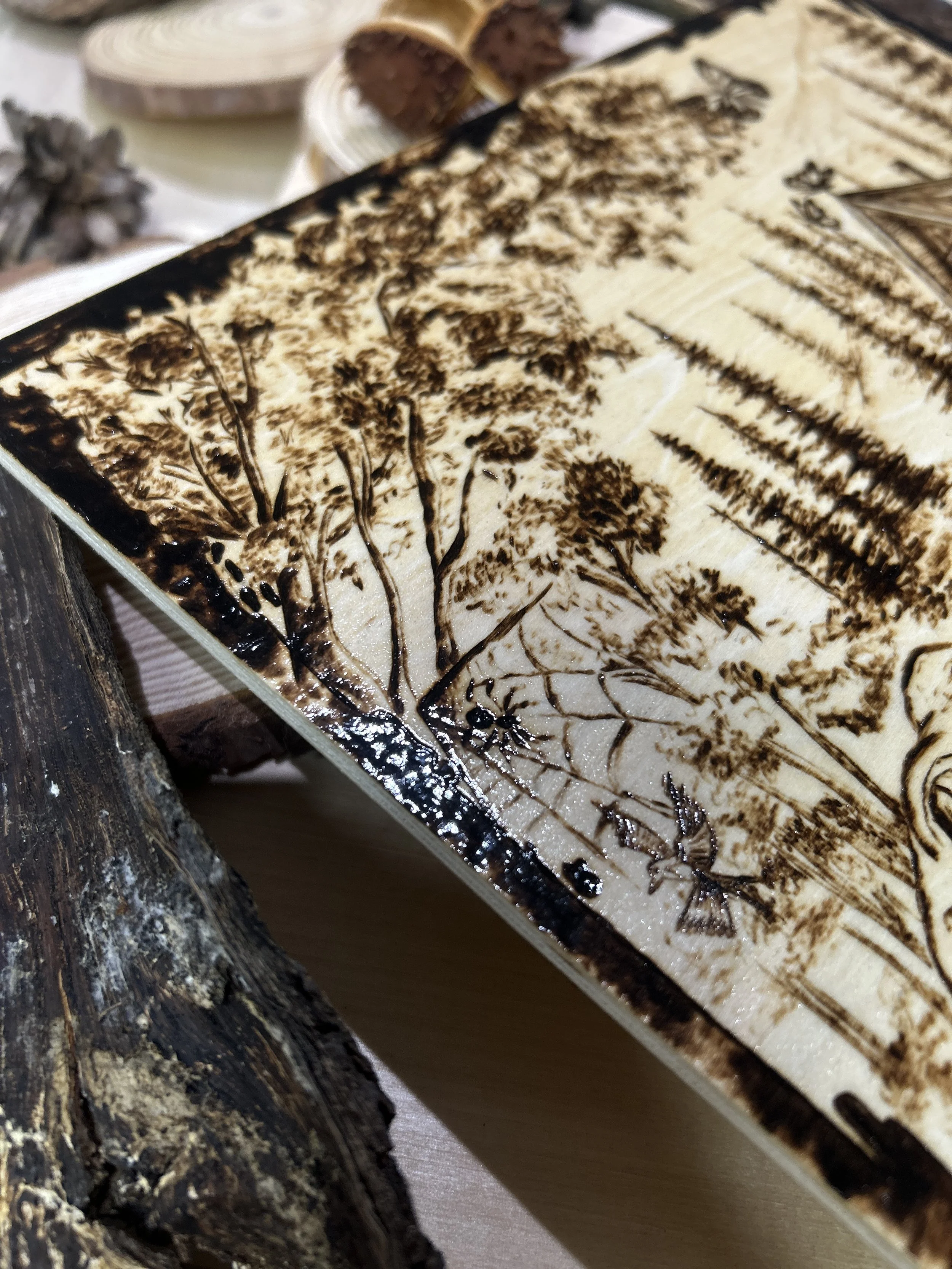 Collection of wood-burned pyrography artworks showcasing handcrafted fantasy art in unique, artisan, one-of-a-kind designs and decor, featuring detailed Dusk Hollow scenes on natural wood