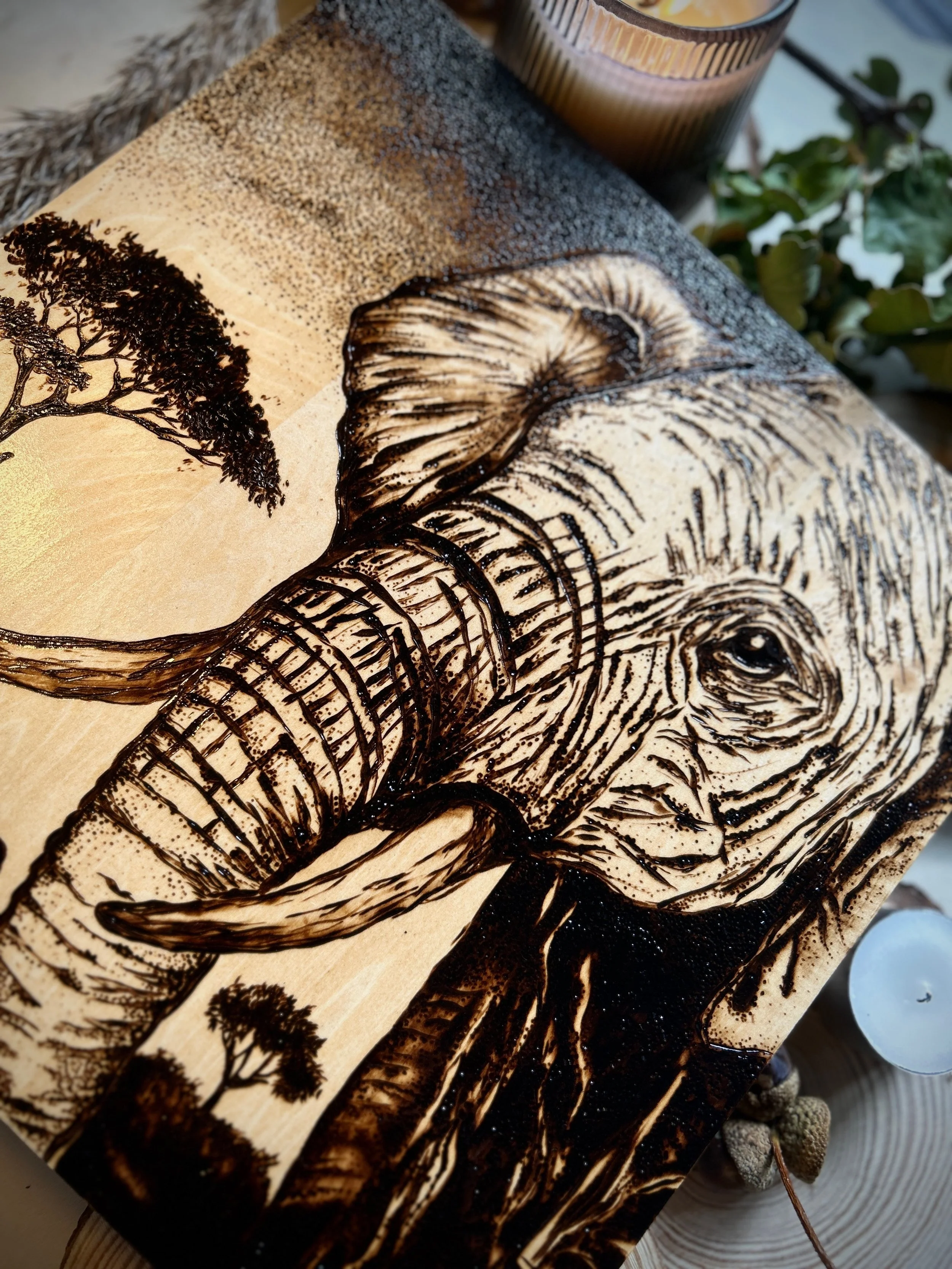 Collection of wood-burned pyrography artworks showcasing handcrafted fantasy art in unique, artisan, one-of-a-kind designs and decor, featuring detailed Savanna Reverie elephant scenes on natural wood