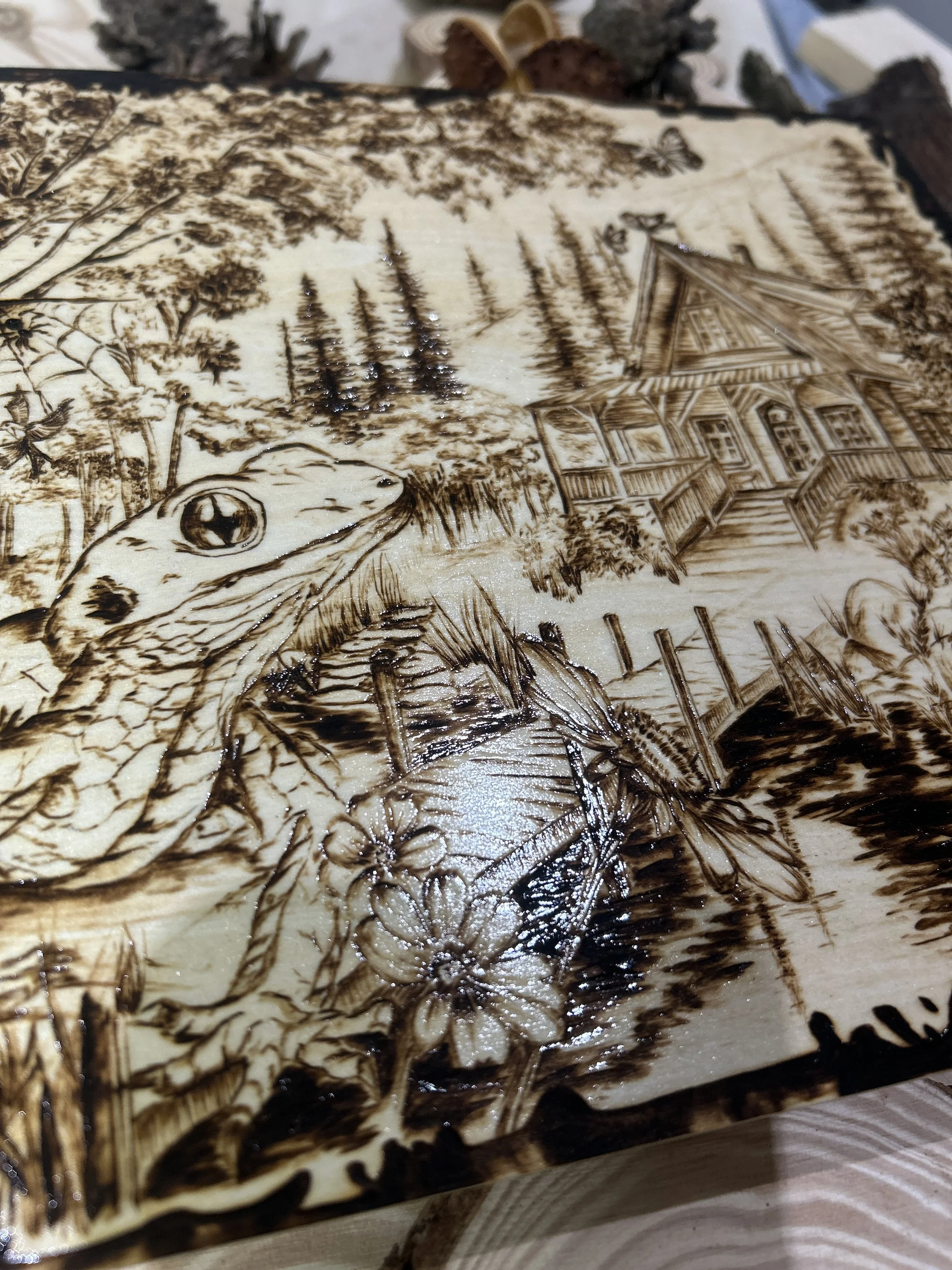 Collection of wood-burned pyrography artworks showcasing handcrafted fantasy art in unique, artisan, one-of-a-kind designs and decor, featuring detailed Dusk Hollow scenes on natural wood