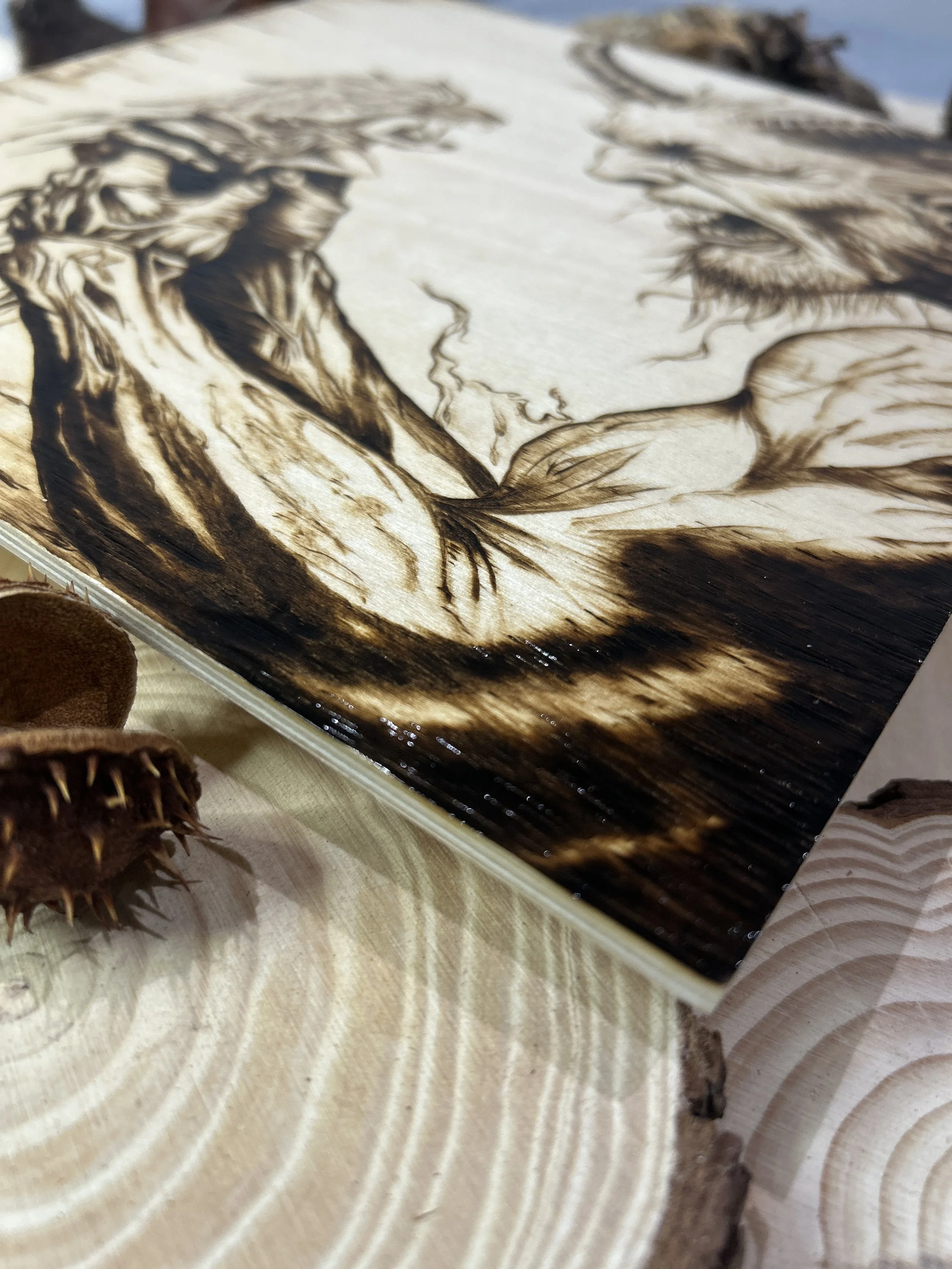 Collection of wood-burned pyrography artworks featuring angels and demons, showcasing handcrafted fantasy art in unique, artisan, one-of-a-kind designs and decor