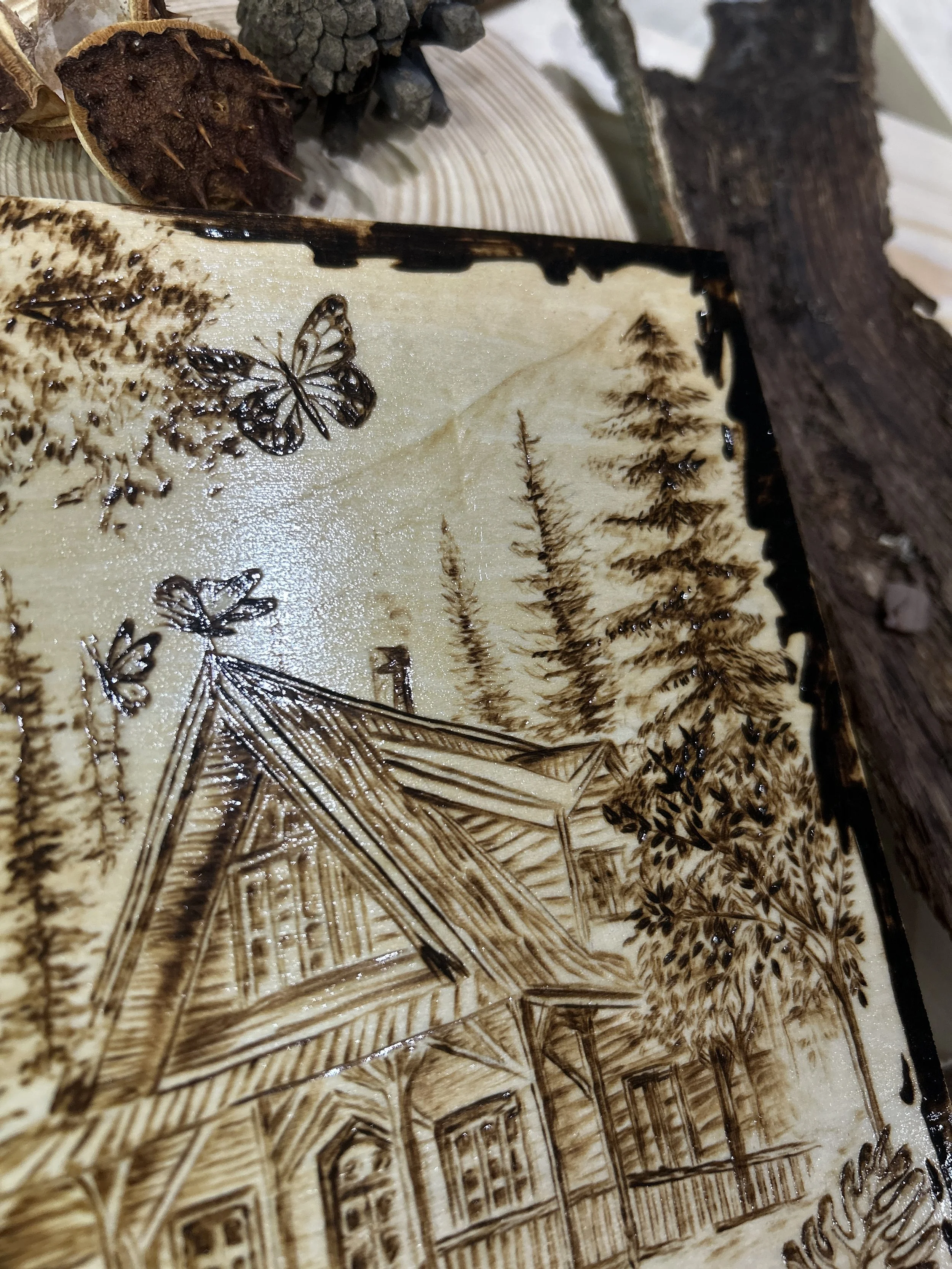 Collection of wood-burned pyrography artworks showcasing handcrafted fantasy art in unique, artisan, one-of-a-kind designs and decor, featuring detailed Dusk Hollow scenes on natural wood