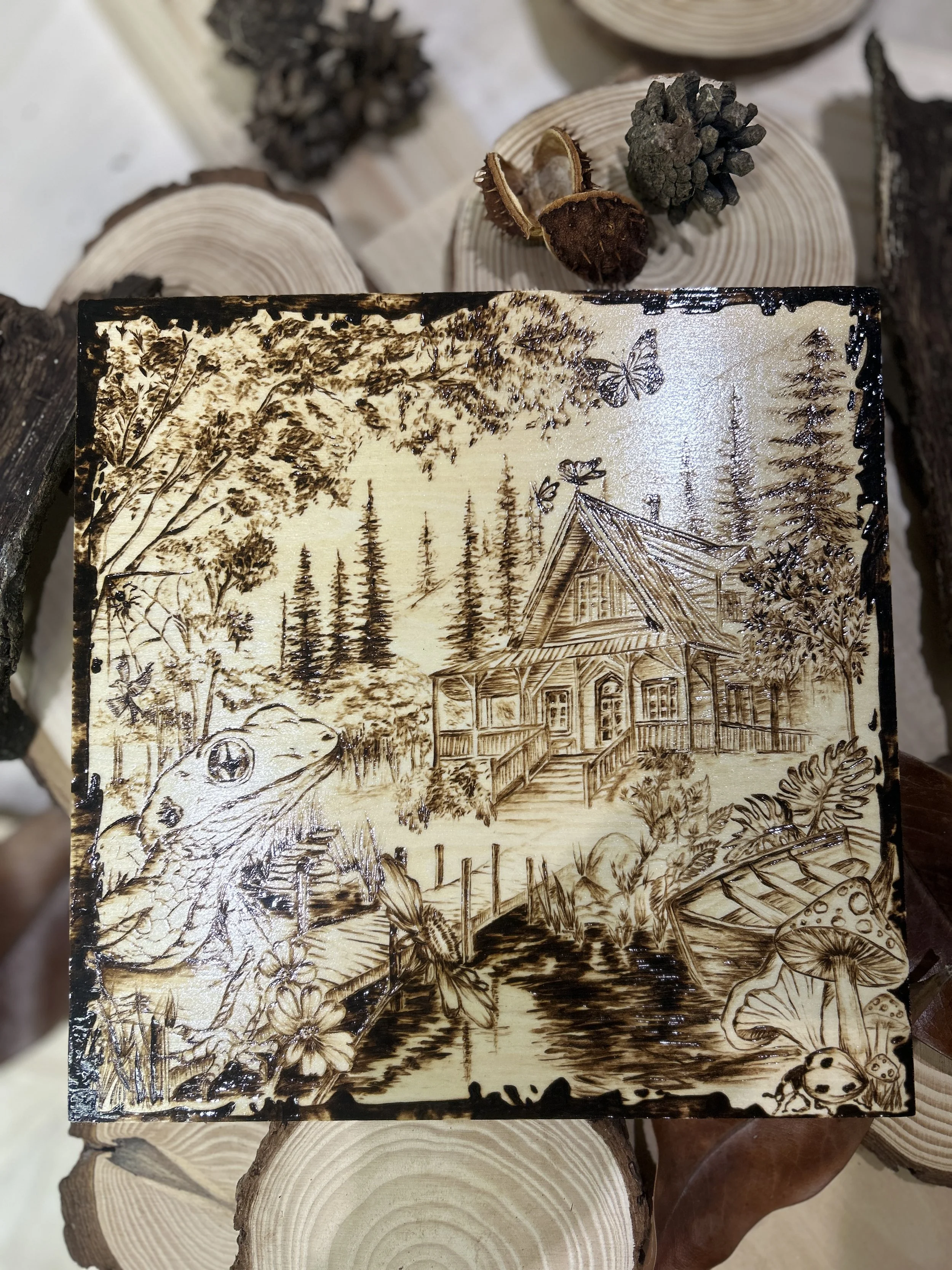 Collection of wood-burned pyrography artworks showcasing handcrafted fantasy art in unique, artisan, one-of-a-kind designs and decor, featuring detailed Dusk Hollow scenes on natural wood