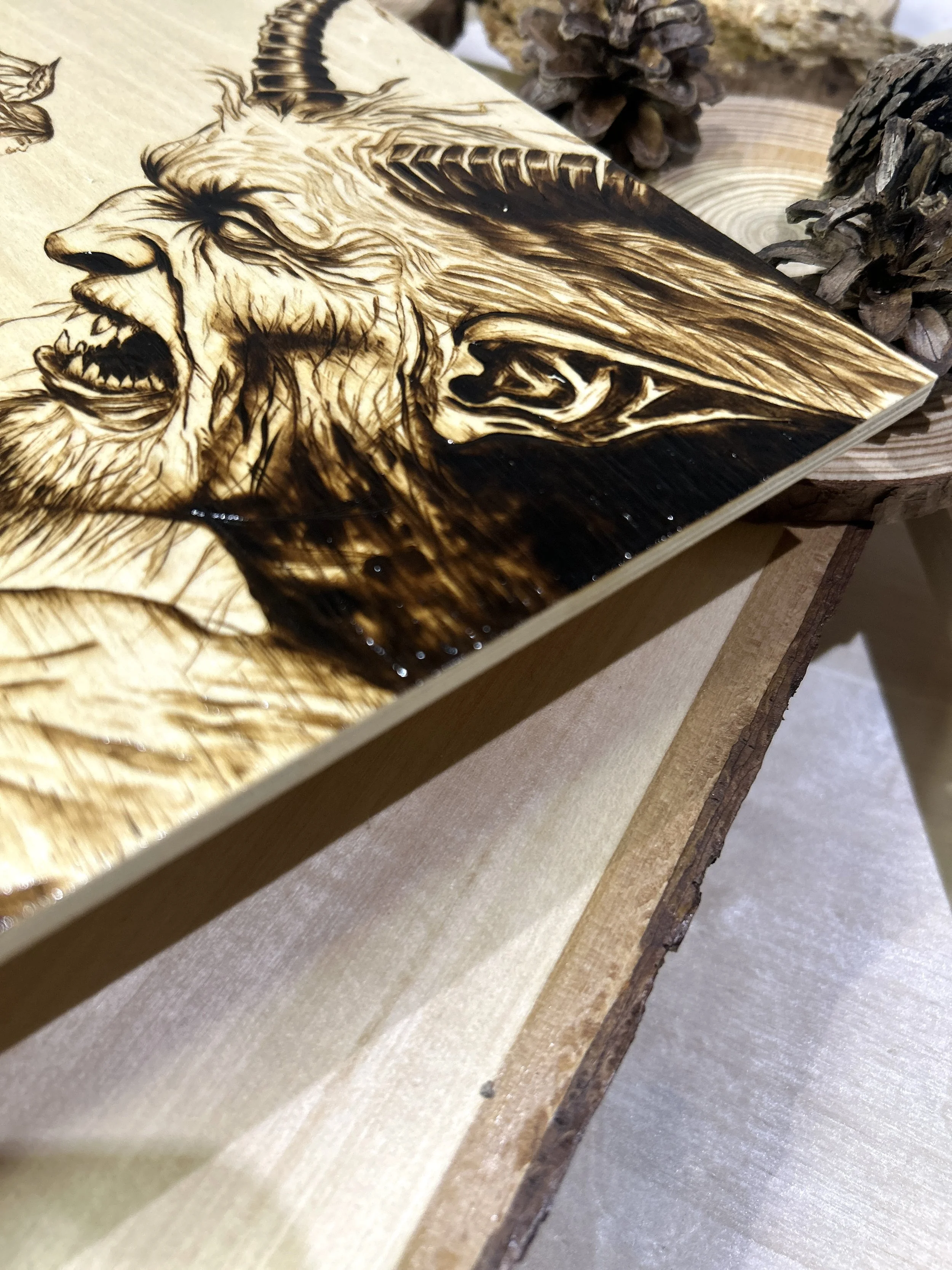 Collection of wood-burned pyrography artworks featuring angels and demons, showcasing handcrafted fantasy art in unique, artisan, one-of-a-kind designs and decor